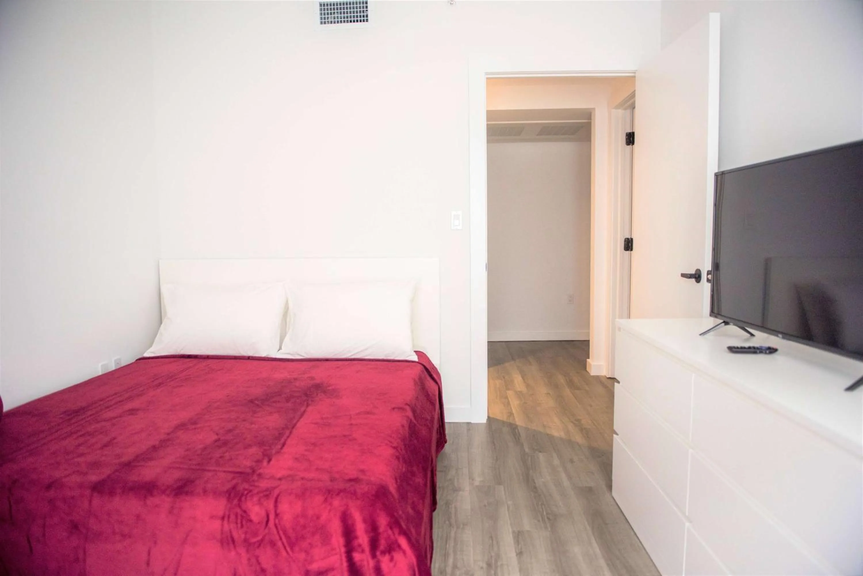 Photo of the whole room, TV/Entertainment Center in 12th & Ocean Suites by LuxUrban