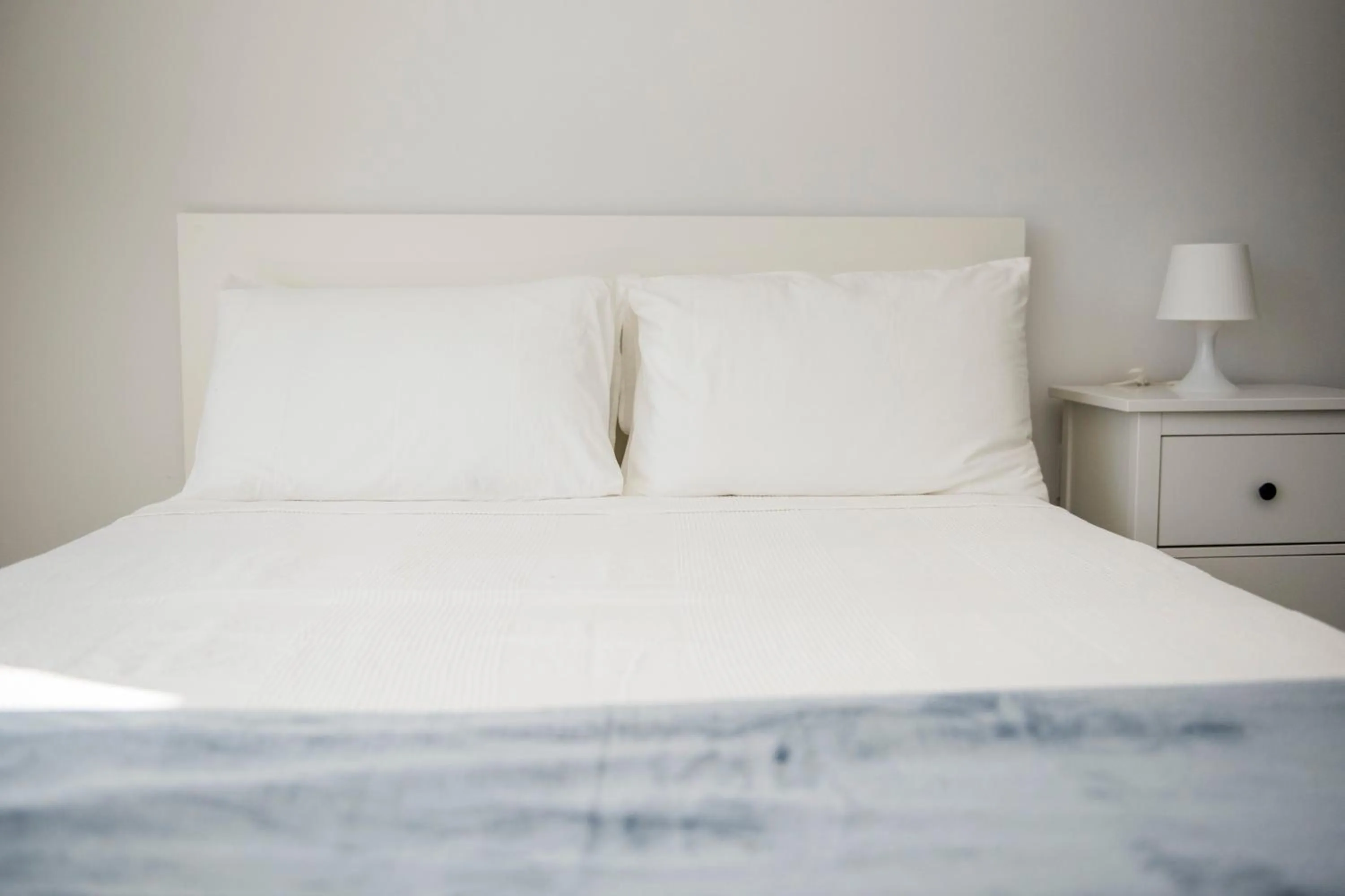 Bed in 12th & Ocean Suites by LuxUrban