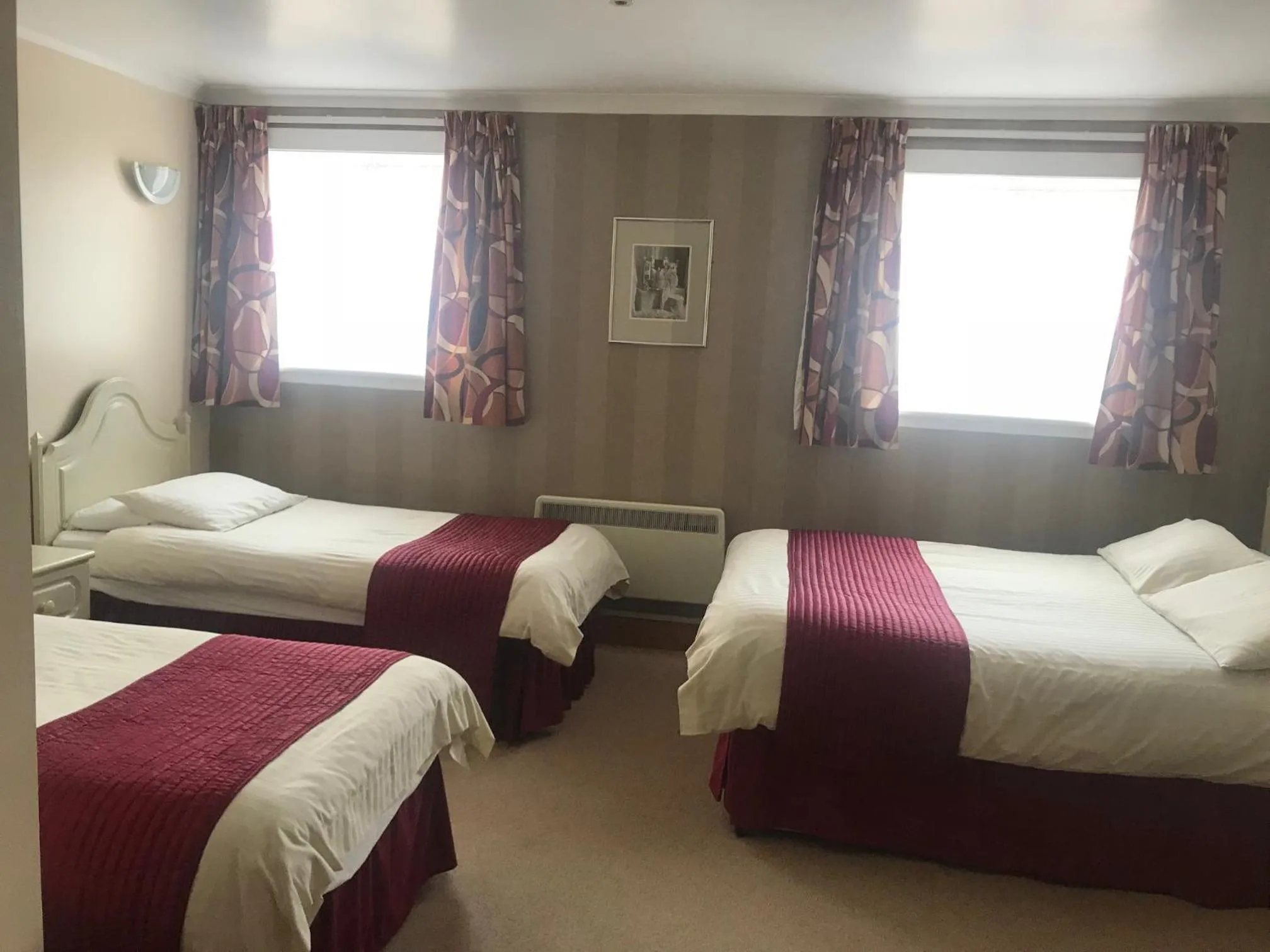 Bed in Empire Travel Lodge