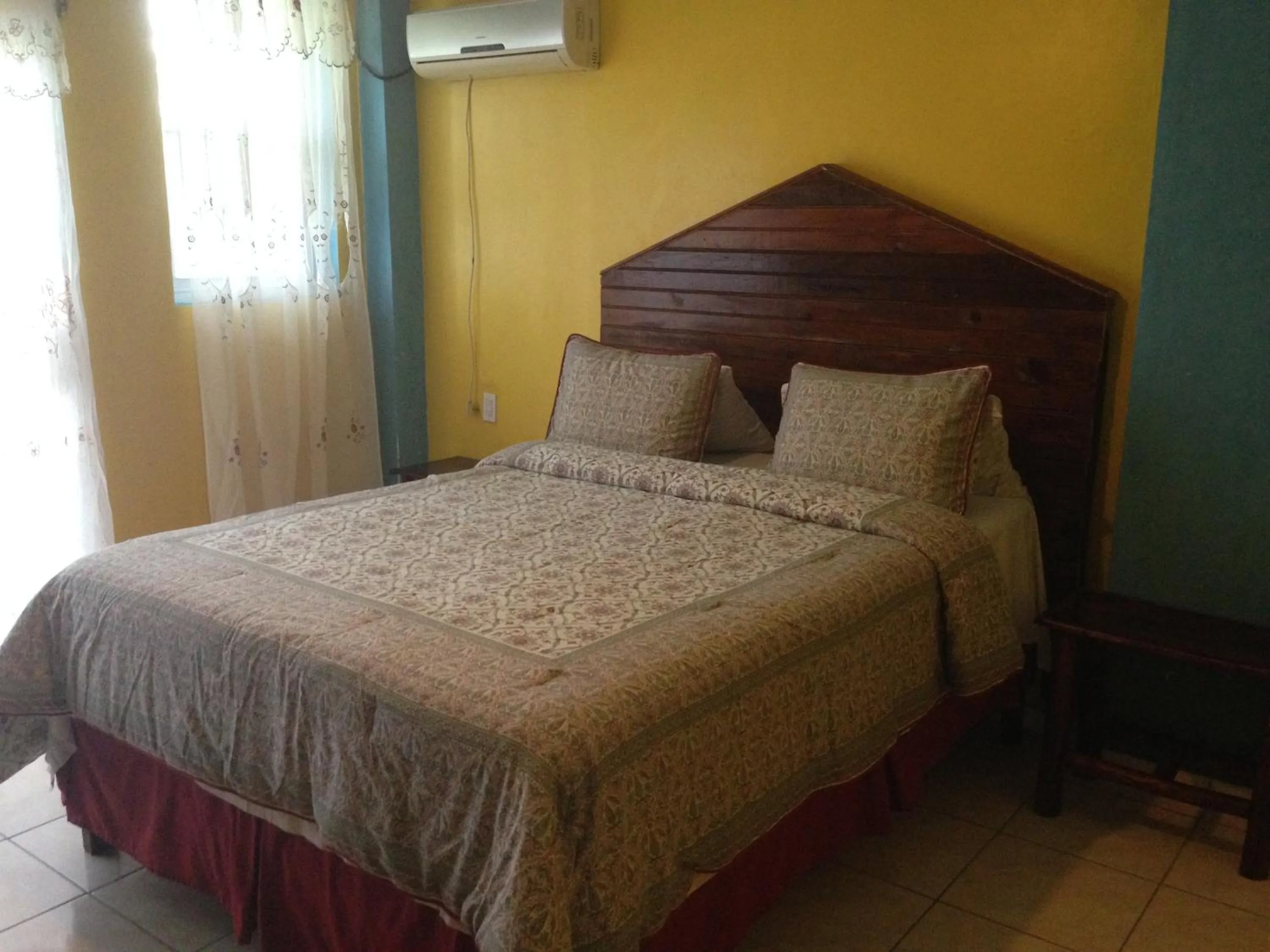 Bed in La Delphina Bed and Breakfast Bar and Grill