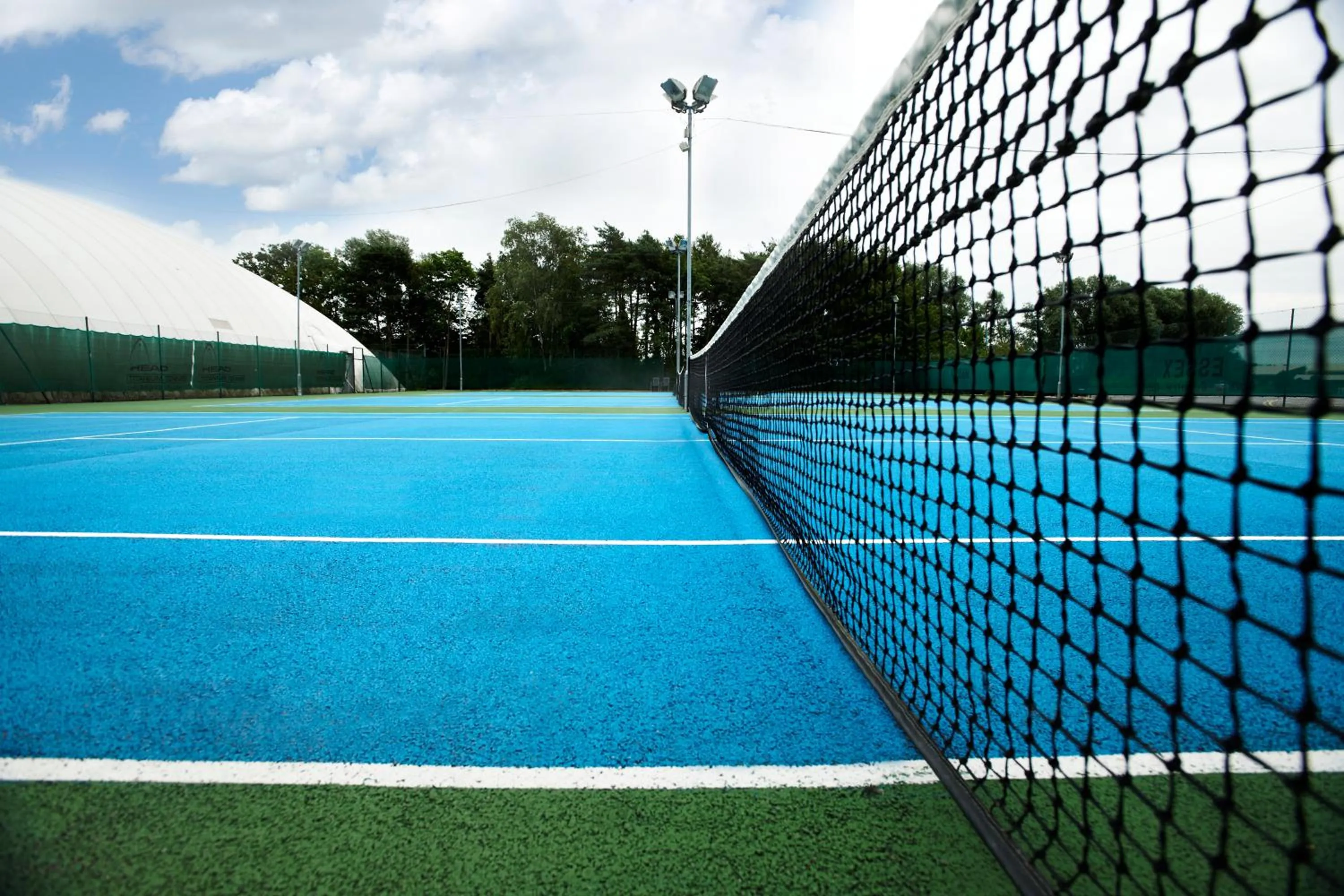Tennis court in The Essex Golf & Country Club Hotel