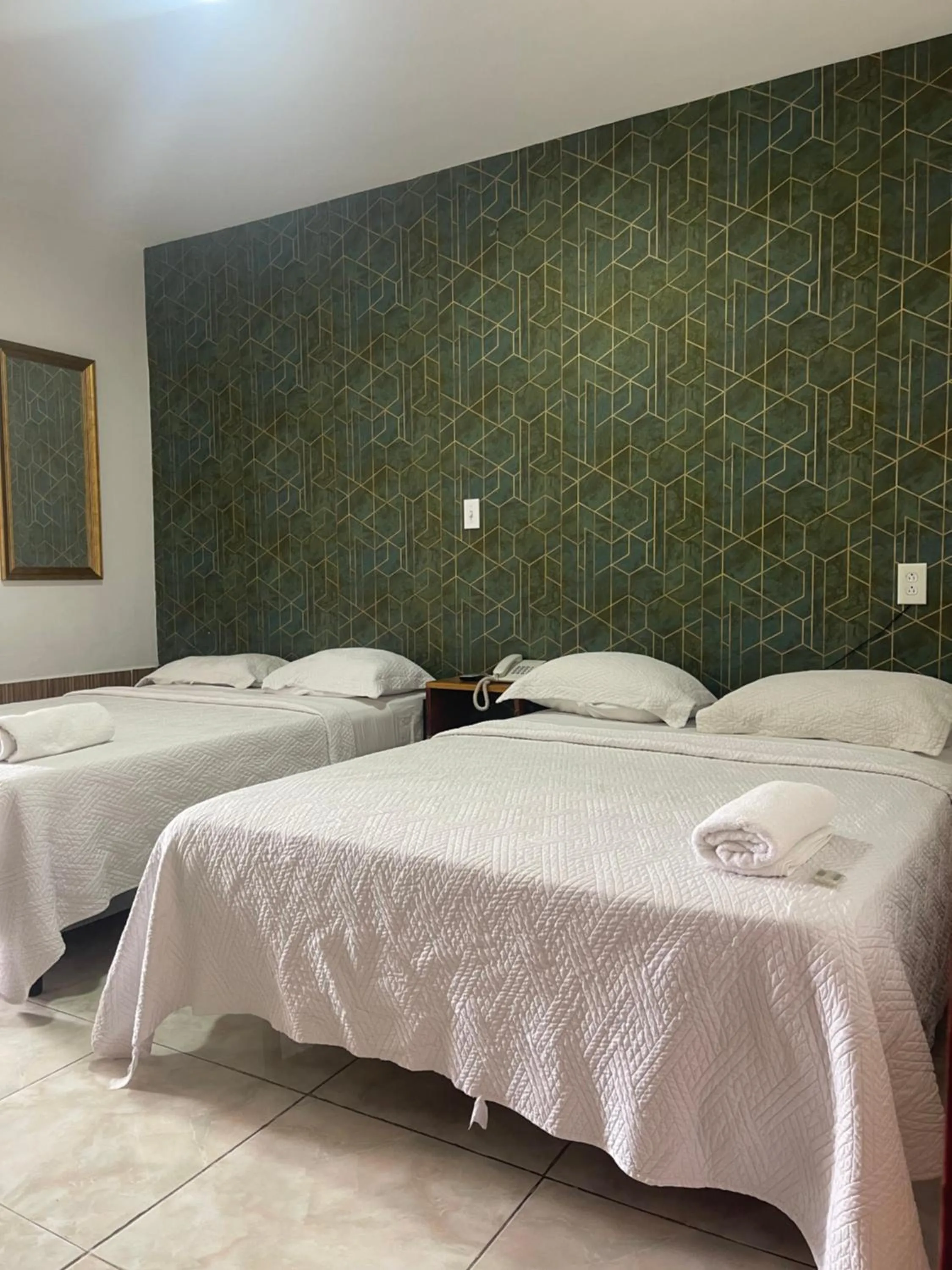 Bed in Hotel Costa Inn