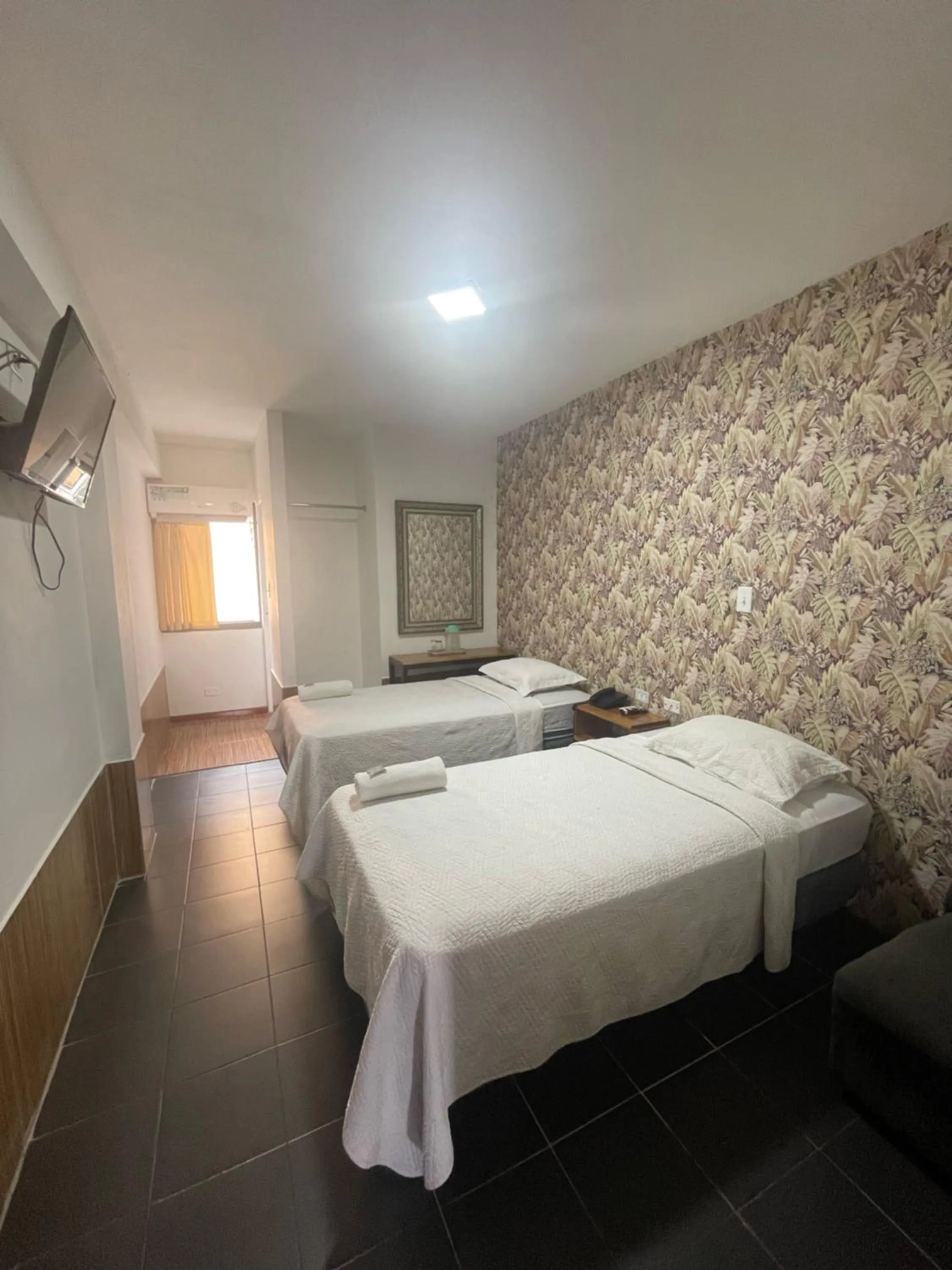 Bed in Hotel Costa Inn