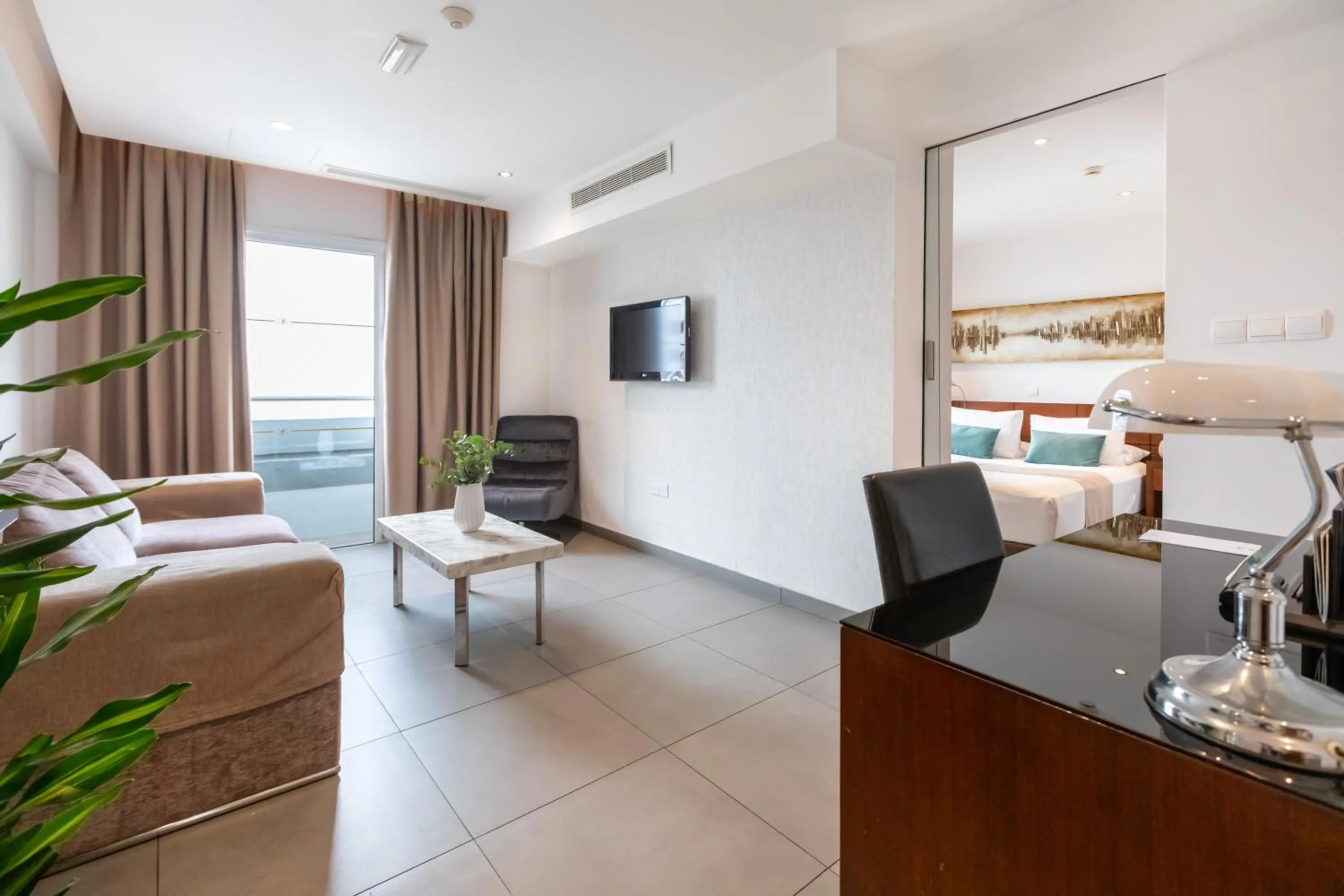 Communal lounge/ TV room, Bed in Achilleos City Hotel