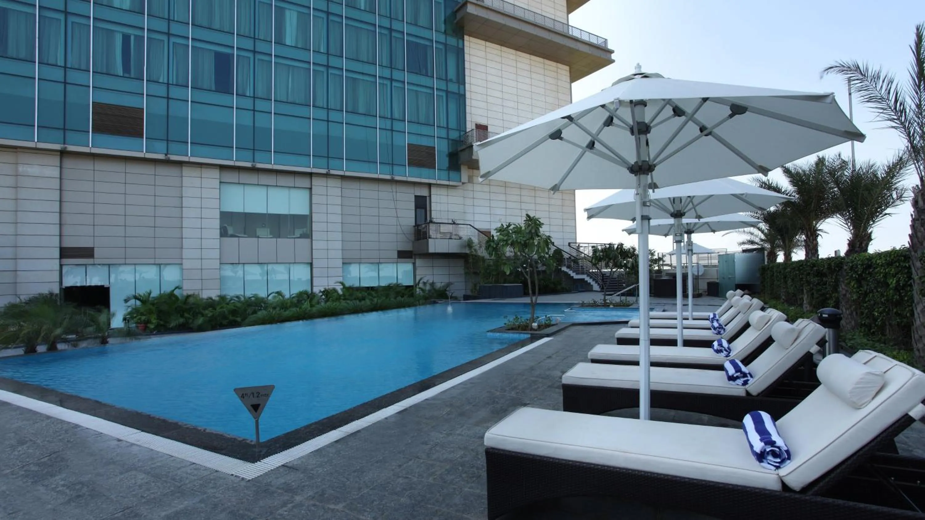 Swimming pool in Crowne Plaza New Delhi Rohini by IHG