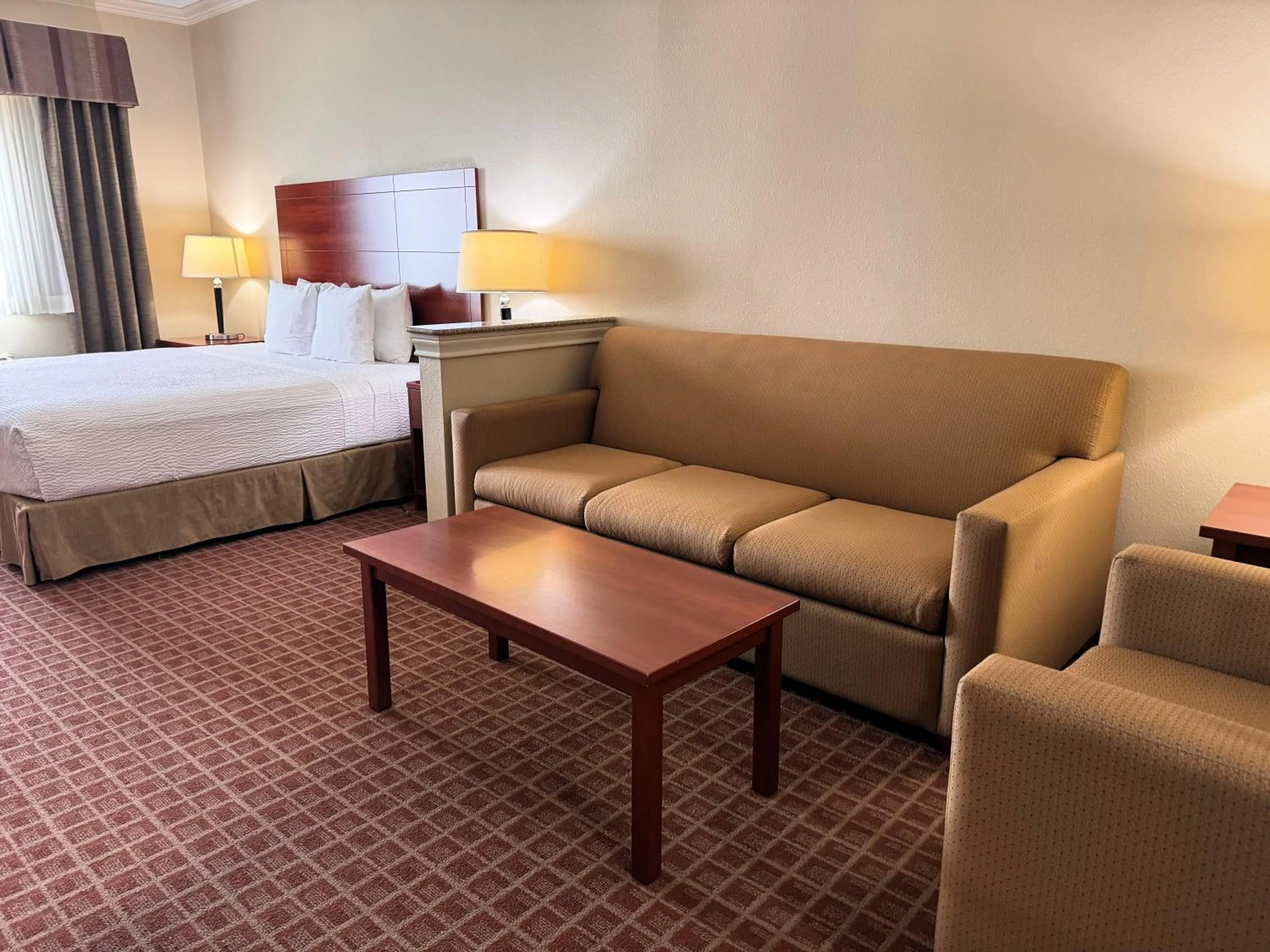 Seating area, Bed in Ramada by Wyndham College Station