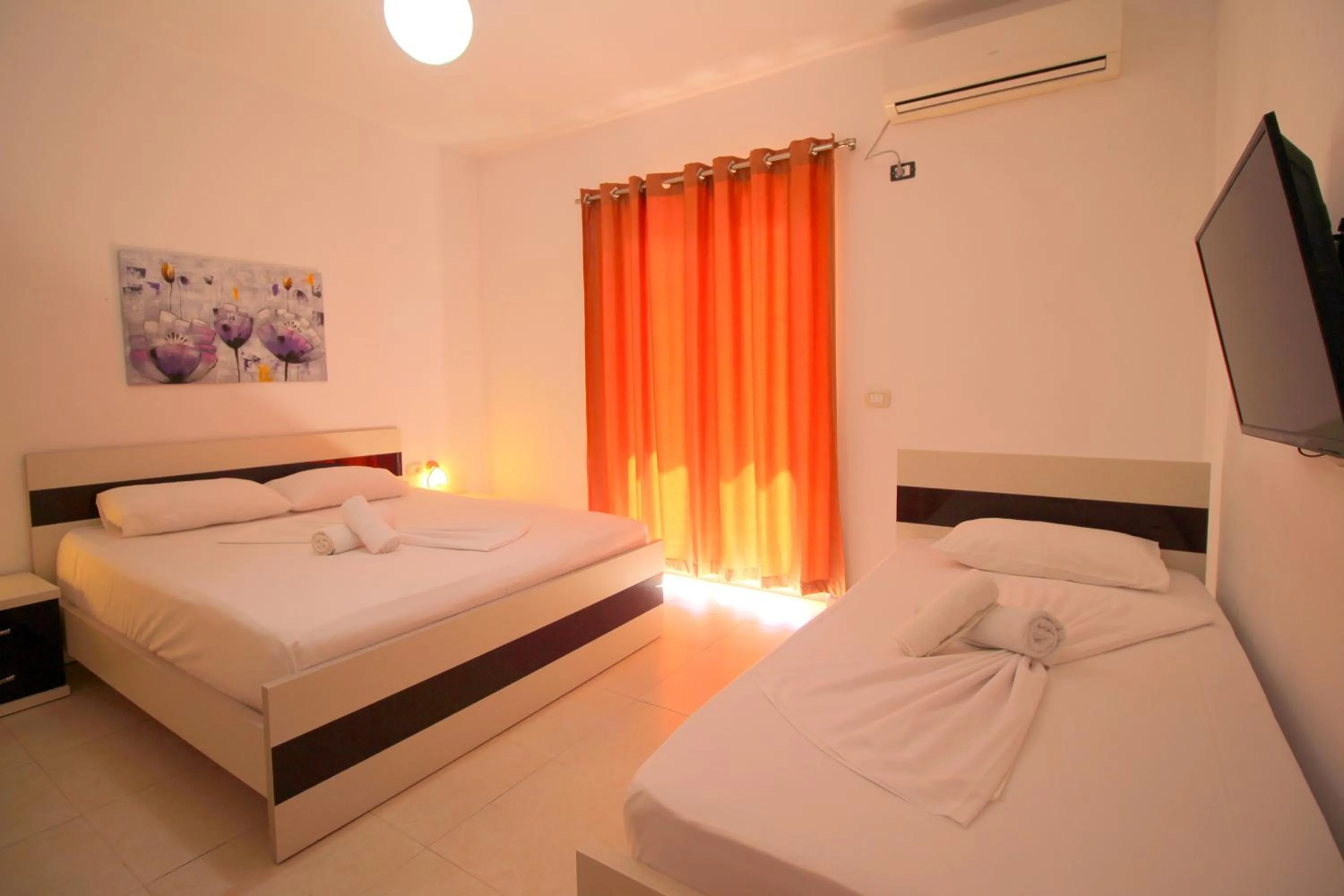 Communal lounge/ TV room, Bed in Hotel Argjiro