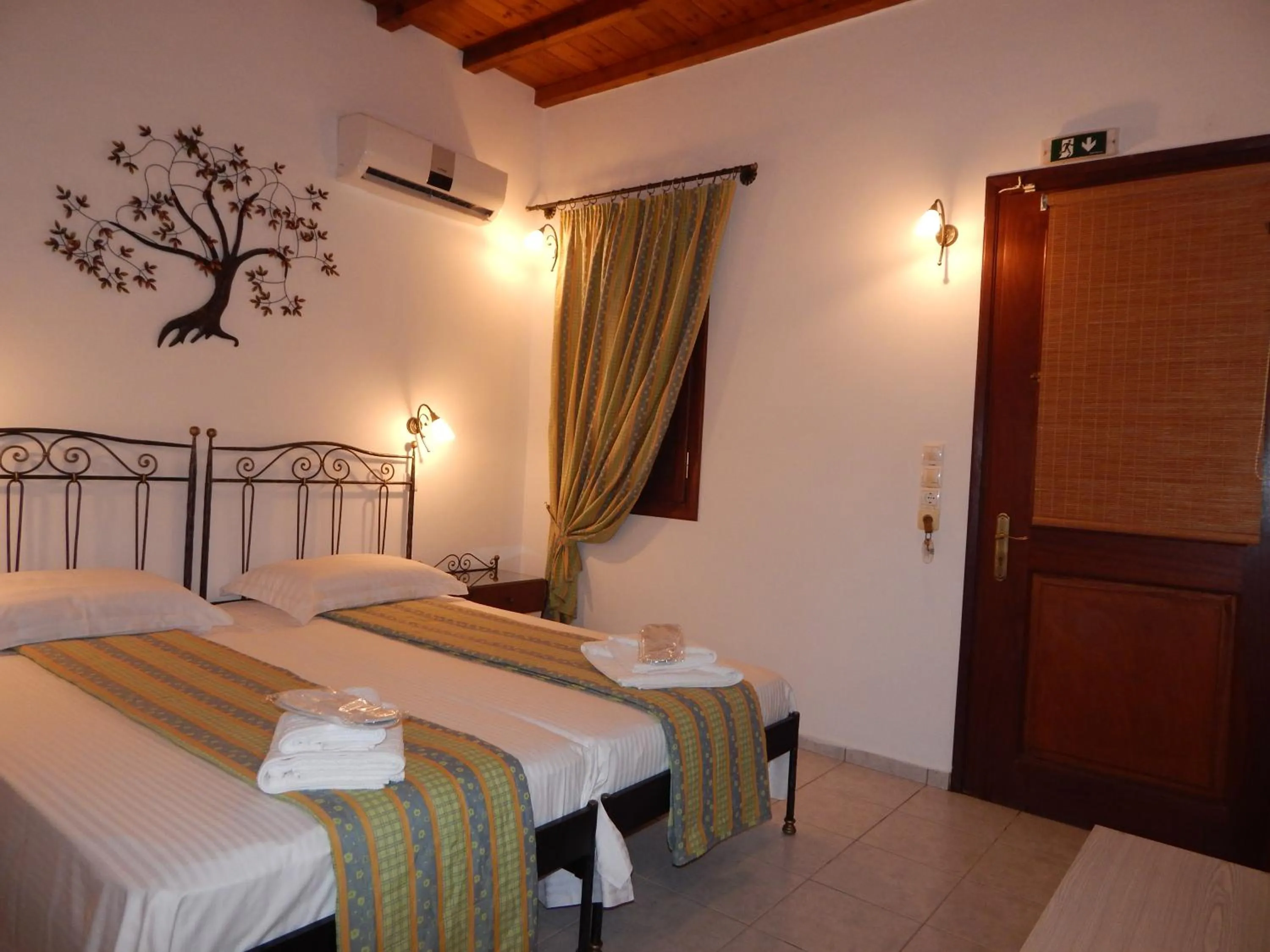 Bed in Tinos Suites & Apartments