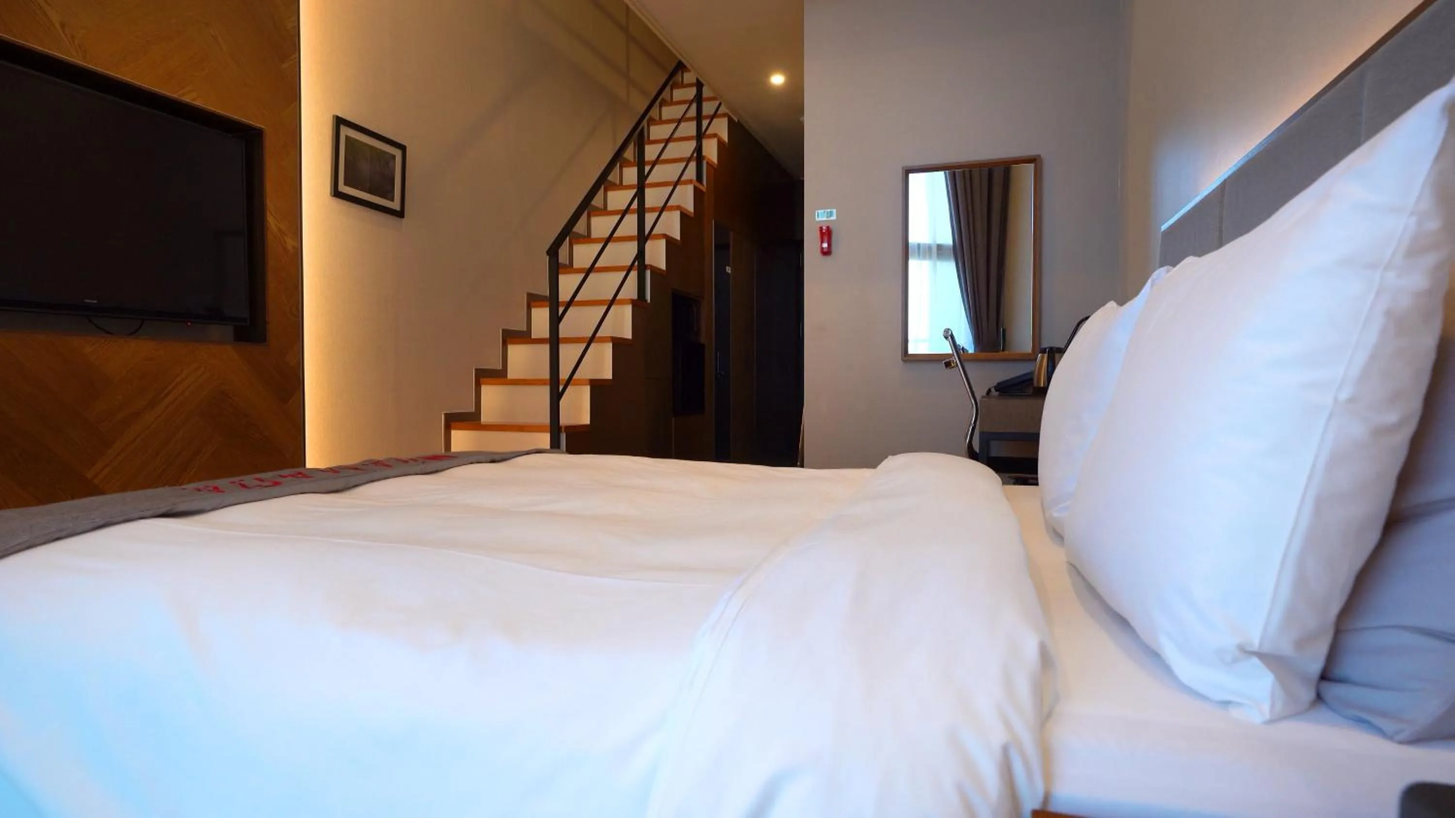 Bed in Ramada Hotel & Suite by Wyndham Gangwon Pyeongchang