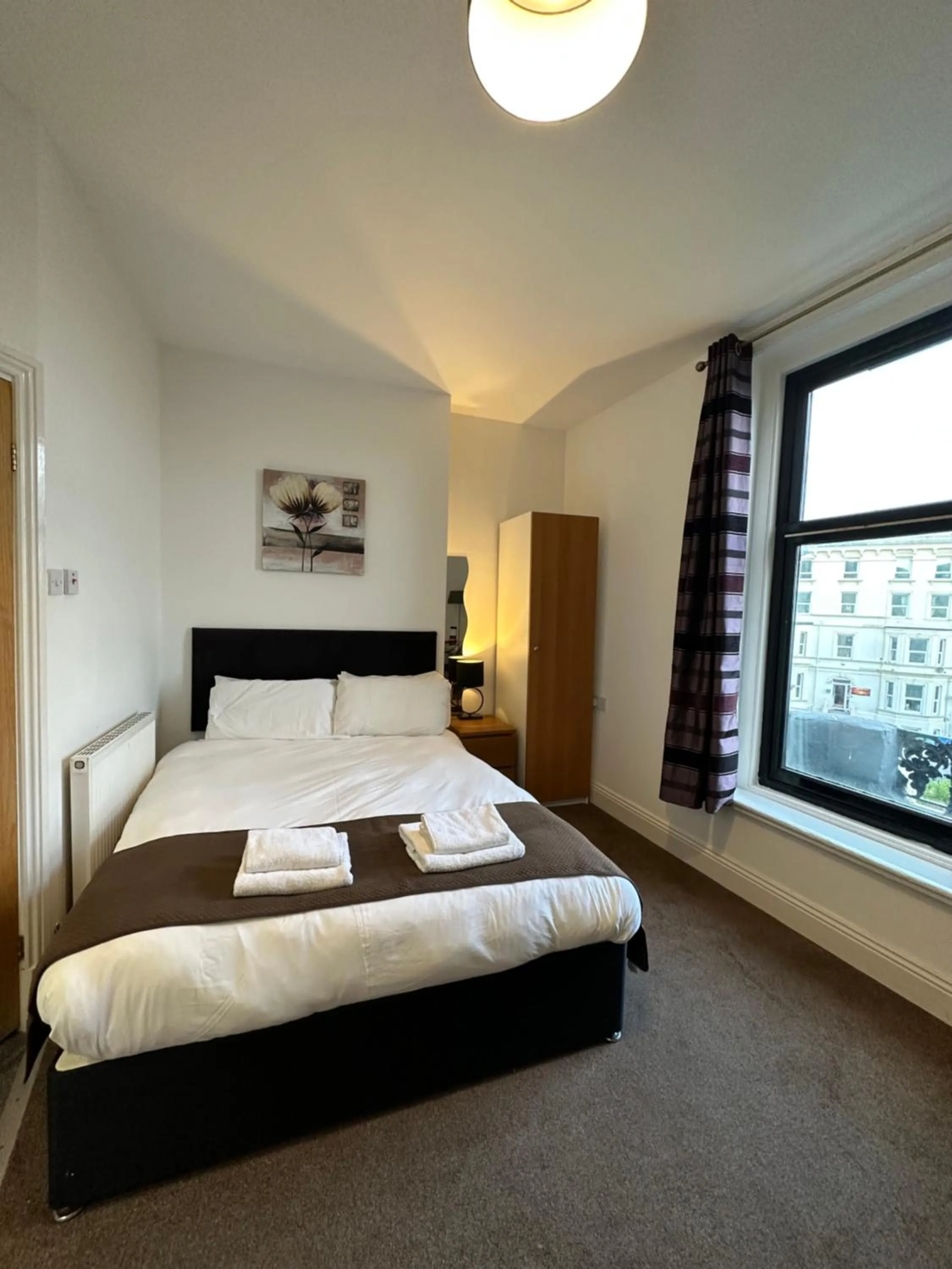 Bed in The Carlton's Holiday Suites