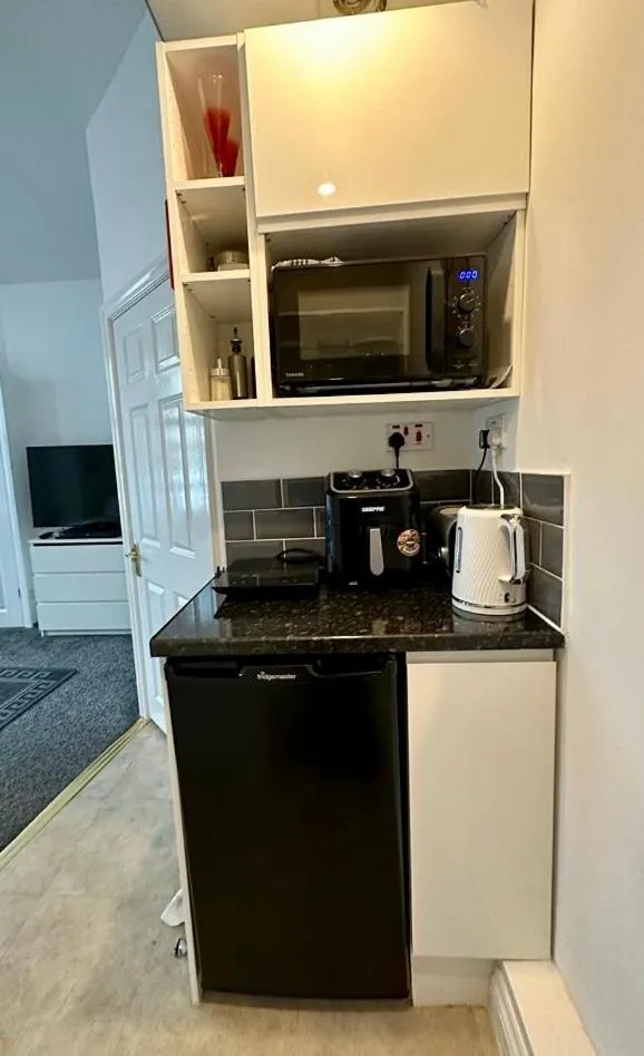 Kitchen or kitchenette in The Carlton's Holiday Suites