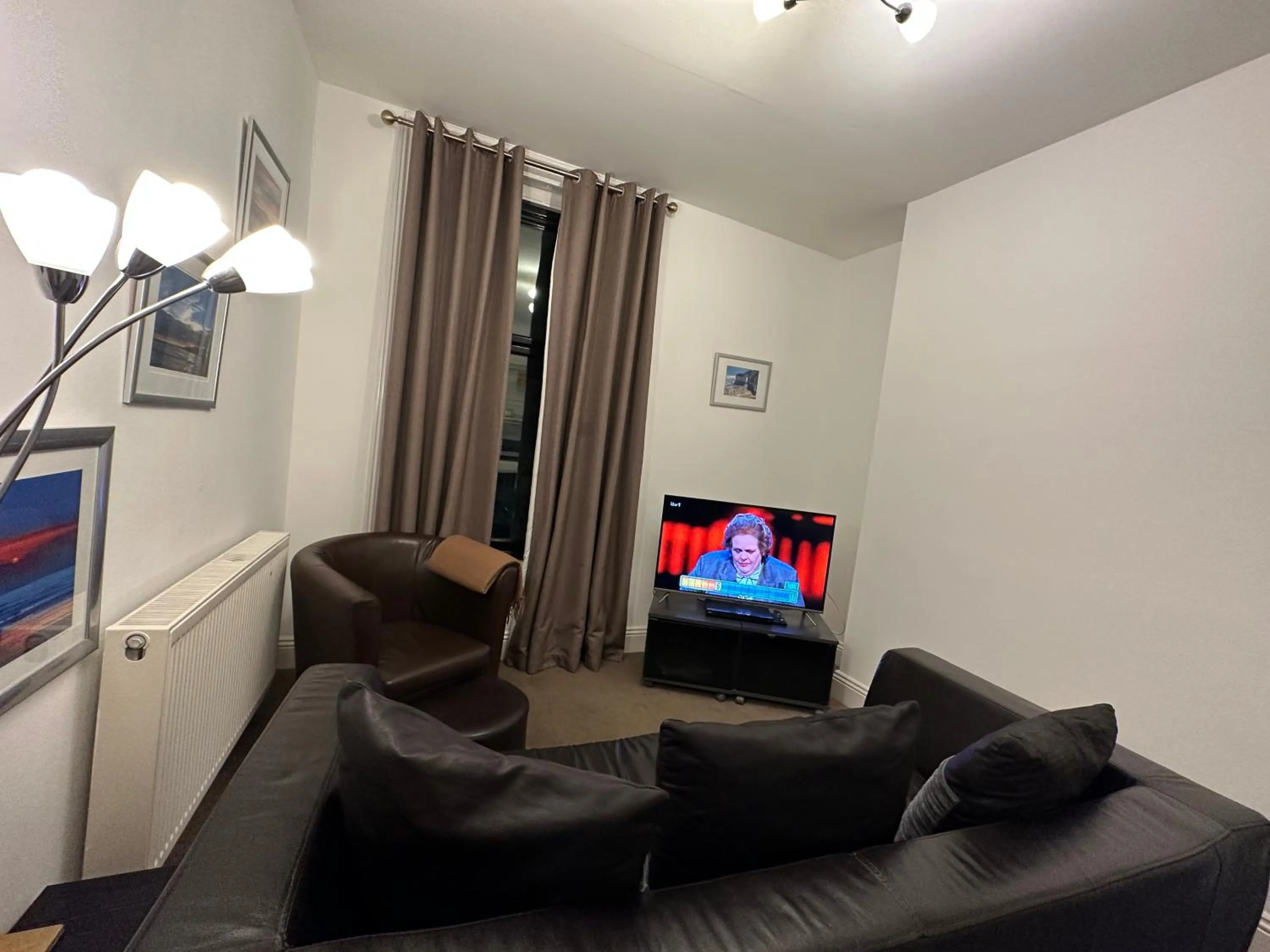 Communal lounge/ TV room in The Carlton's Holiday Suites