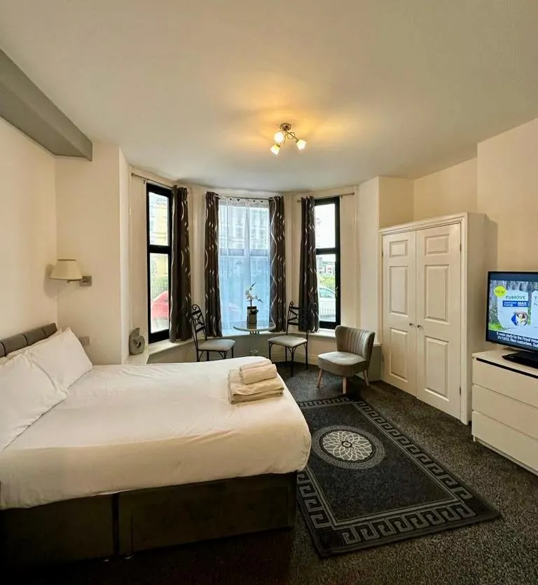 Photo of the whole room, Bed in The Carlton's Holiday Suites