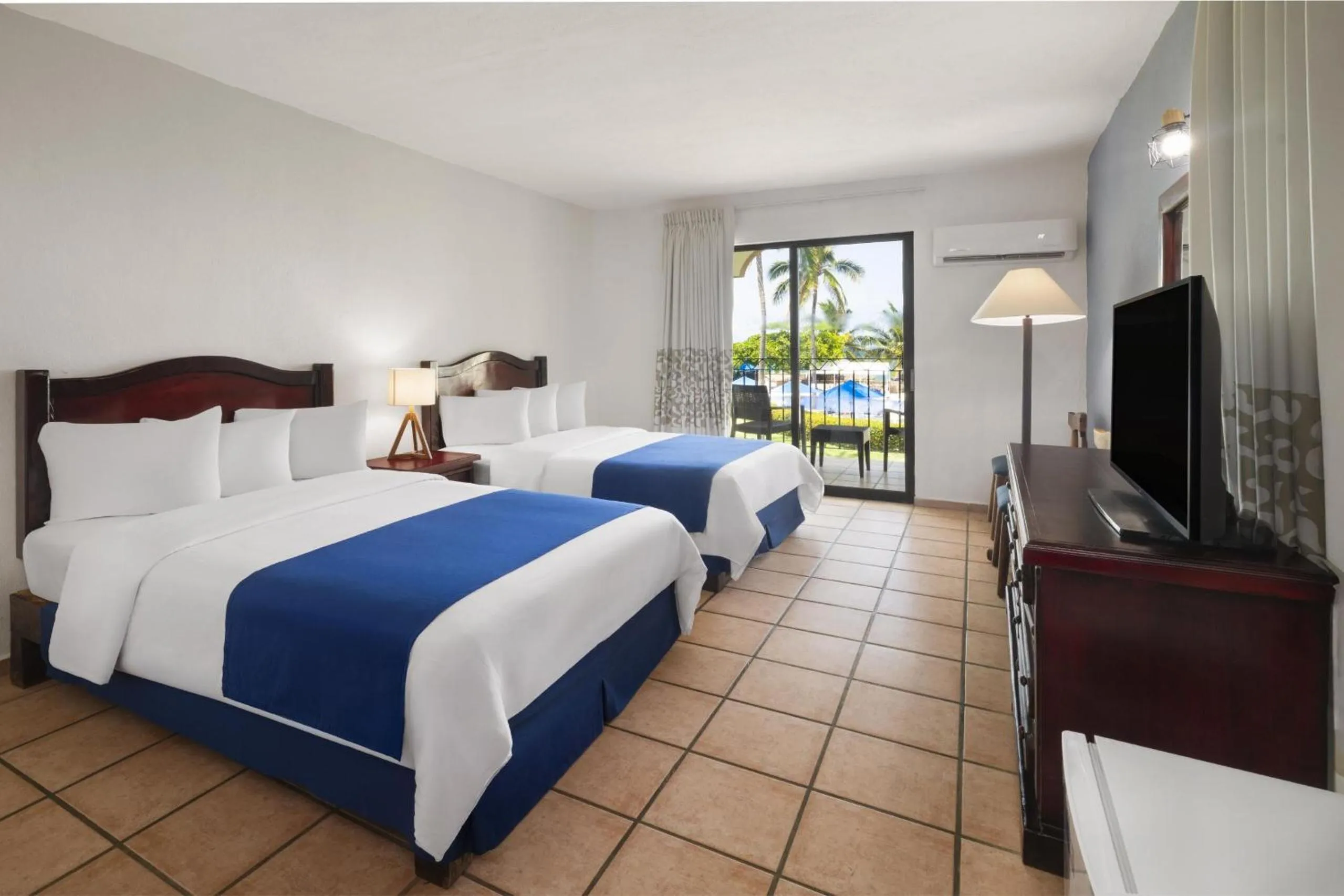 Bed in Grand Decameron Complex Bucerias, A Trademark All-Inclusive Resort