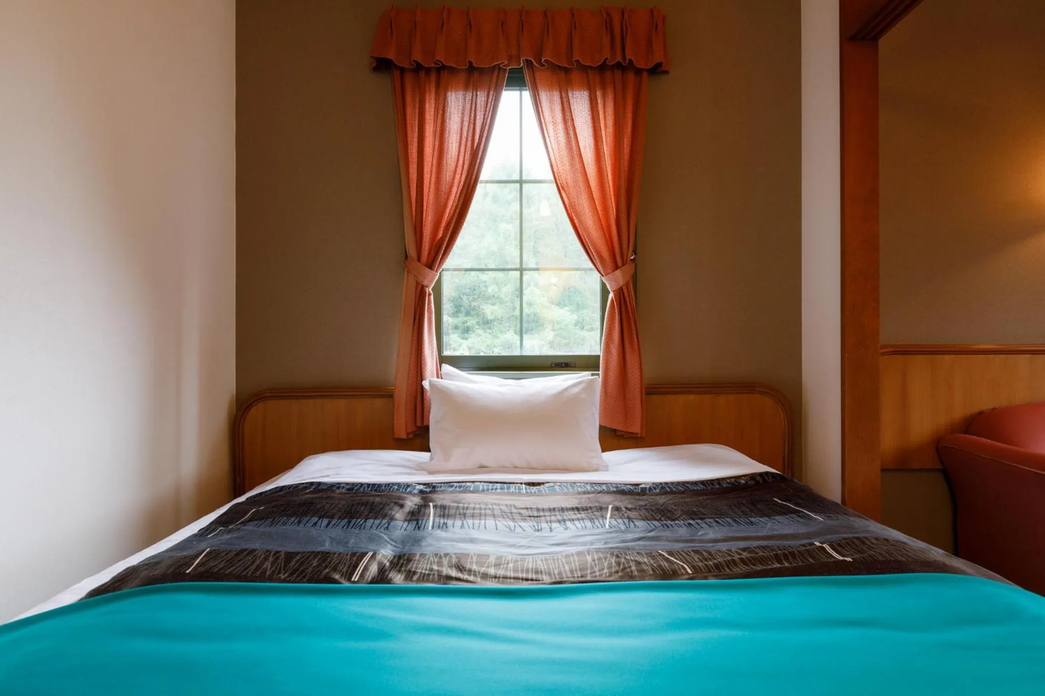 Bed in ホテルけやきの樹