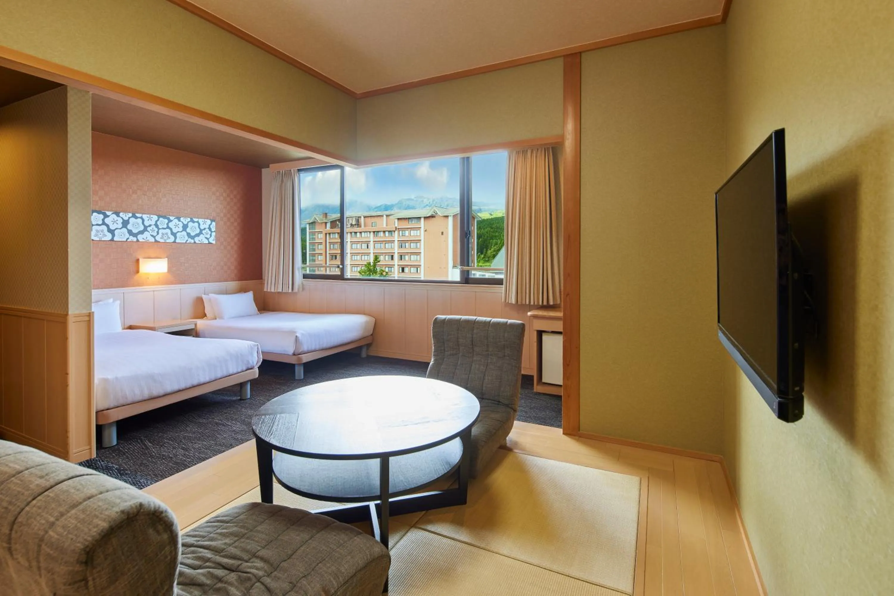 Living room, Bed in Kamenoi Hotel Aso Park Resort