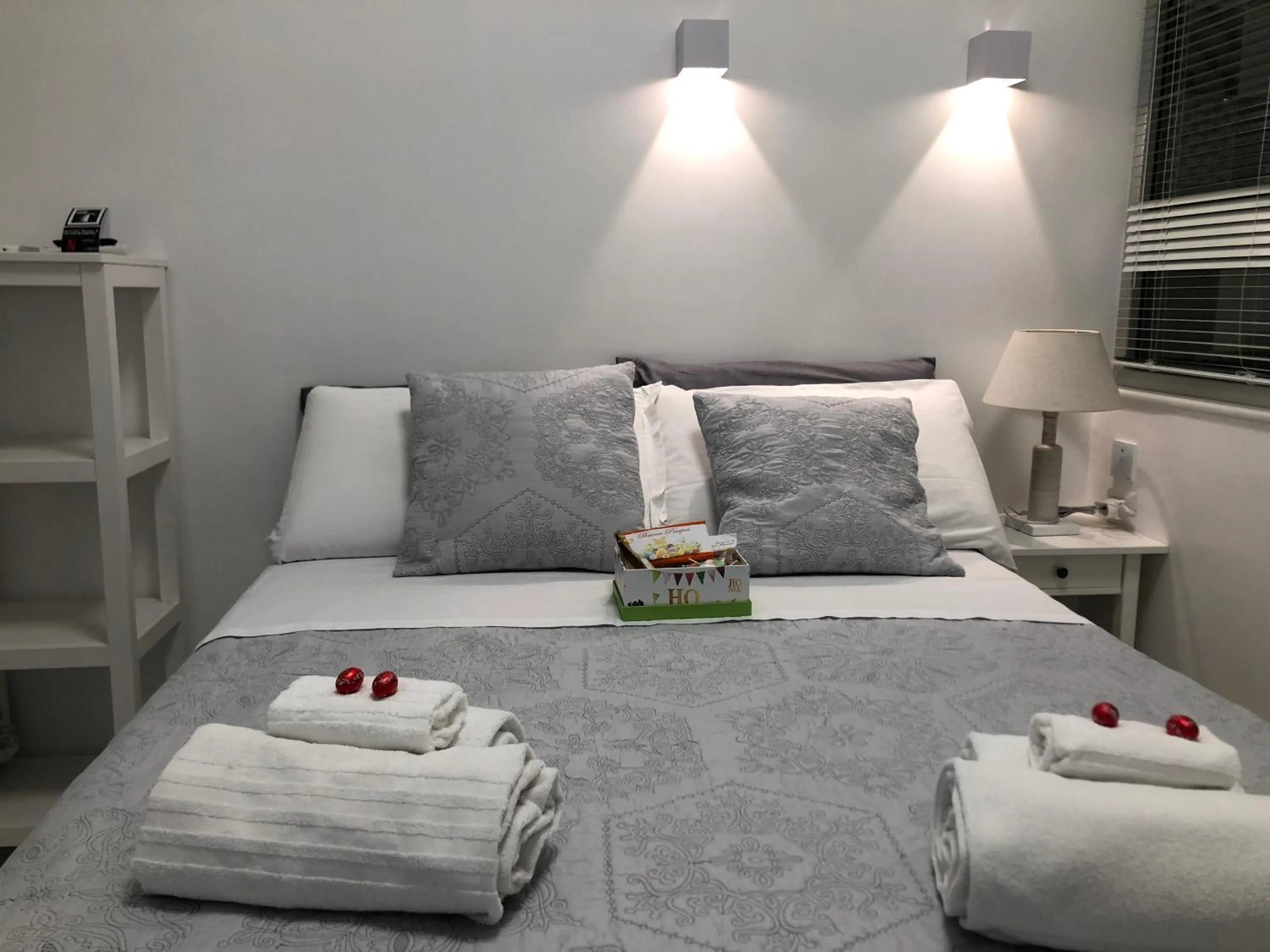 Bed, Seating Area in White Room