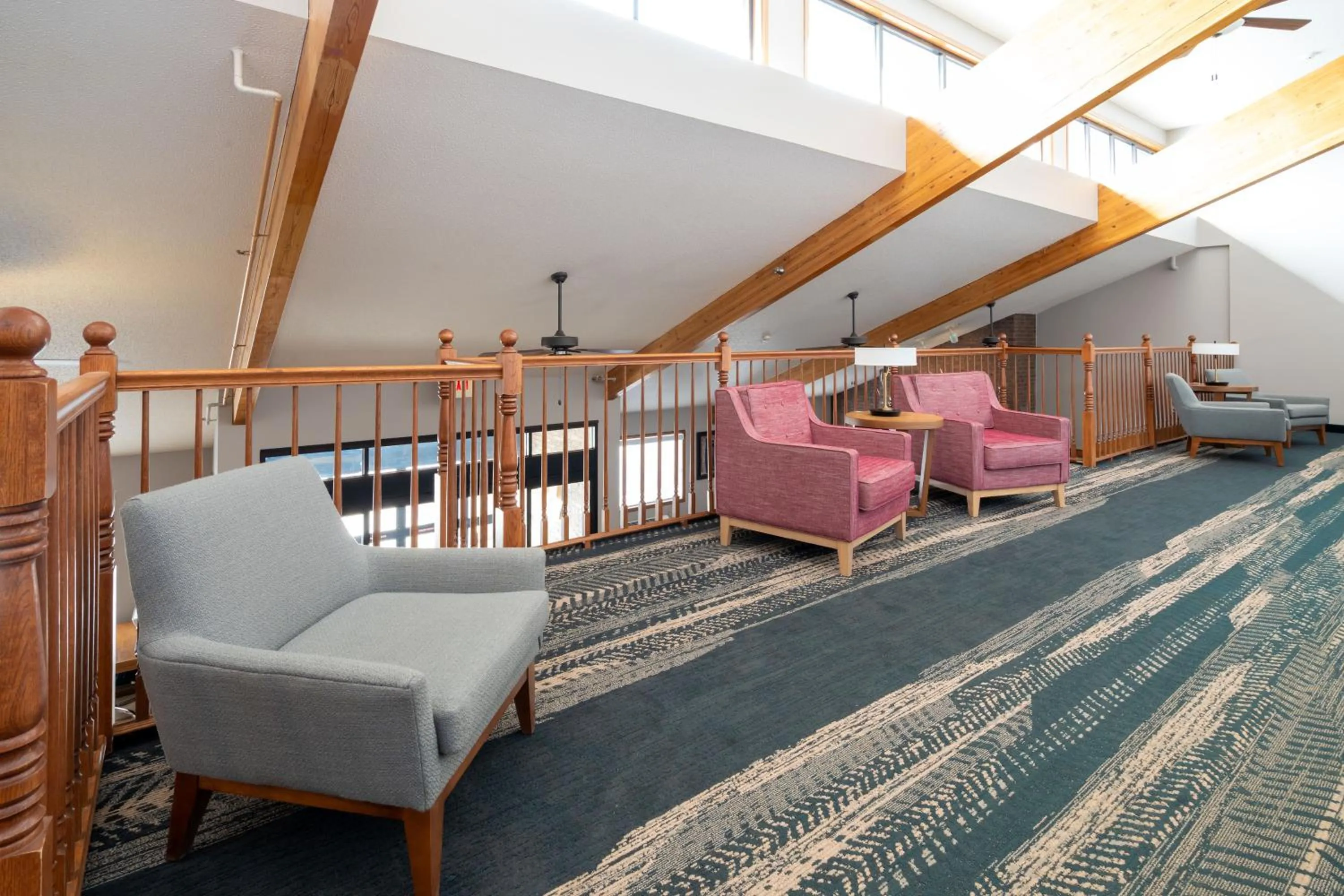 Seating area, Bed in AmericInn by Wyndham Valley City Conference Center