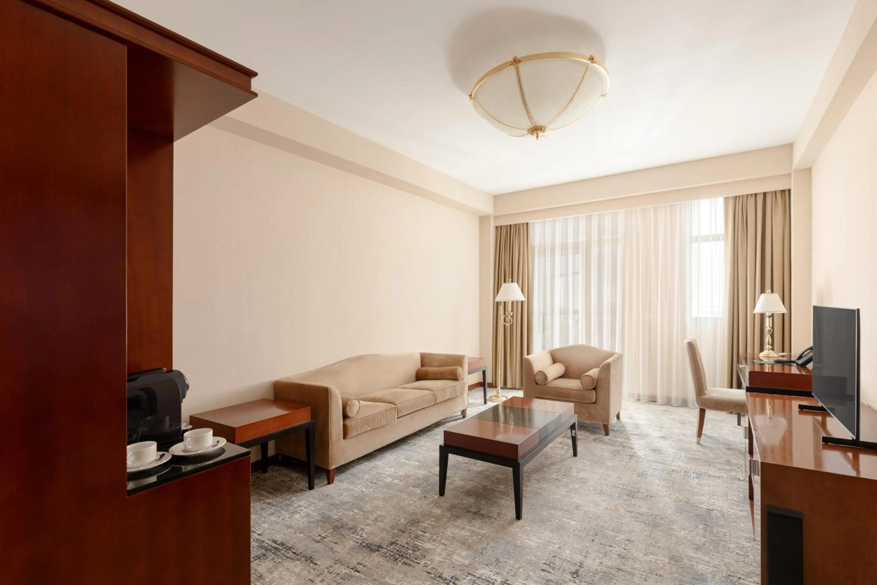 Living room, Bed in Ramada Plaza by Wyndham Gence