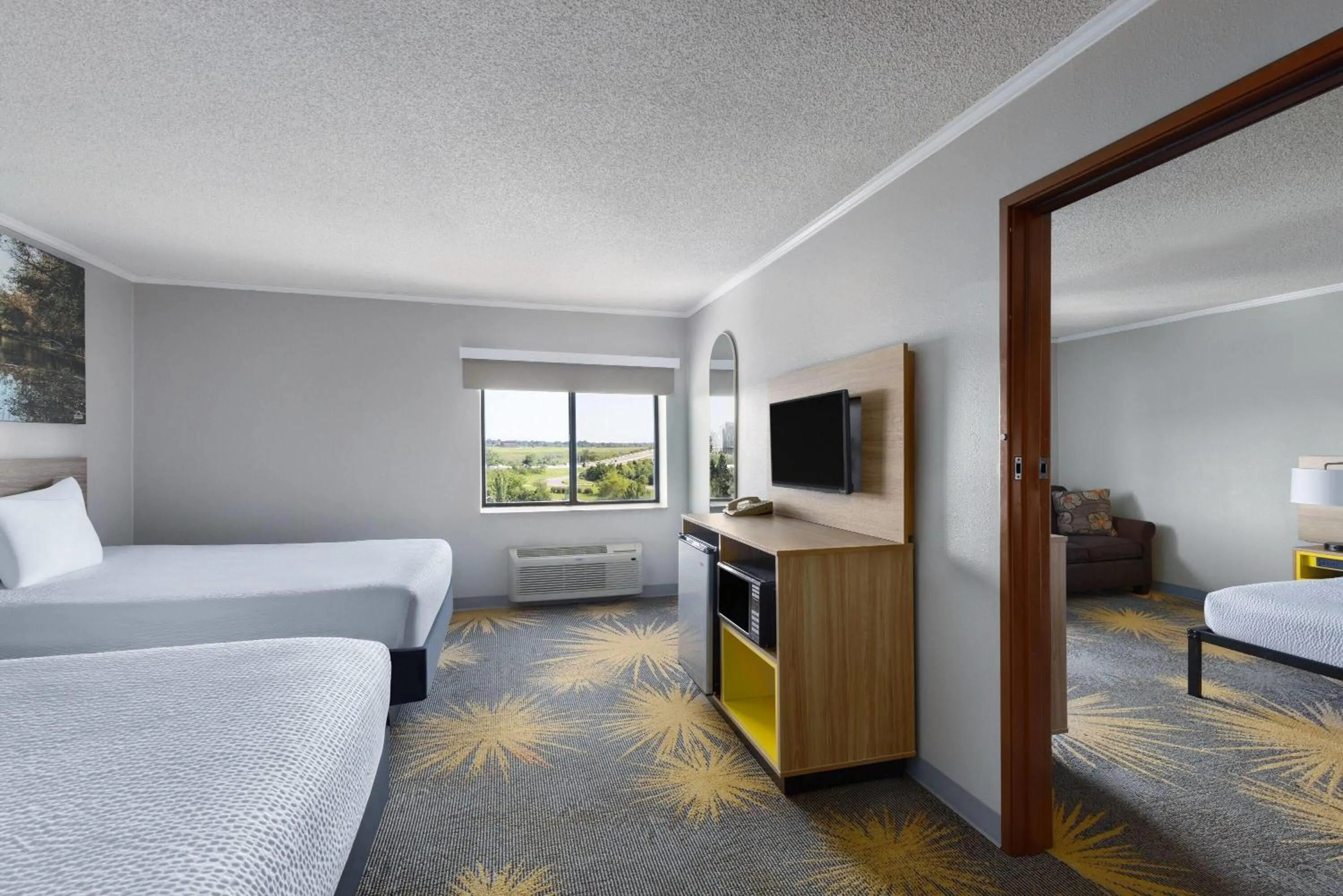 Photo of the whole room, Bed in Days Inn & Suites by Wyndham Kansas City - CHIEFS Stadium