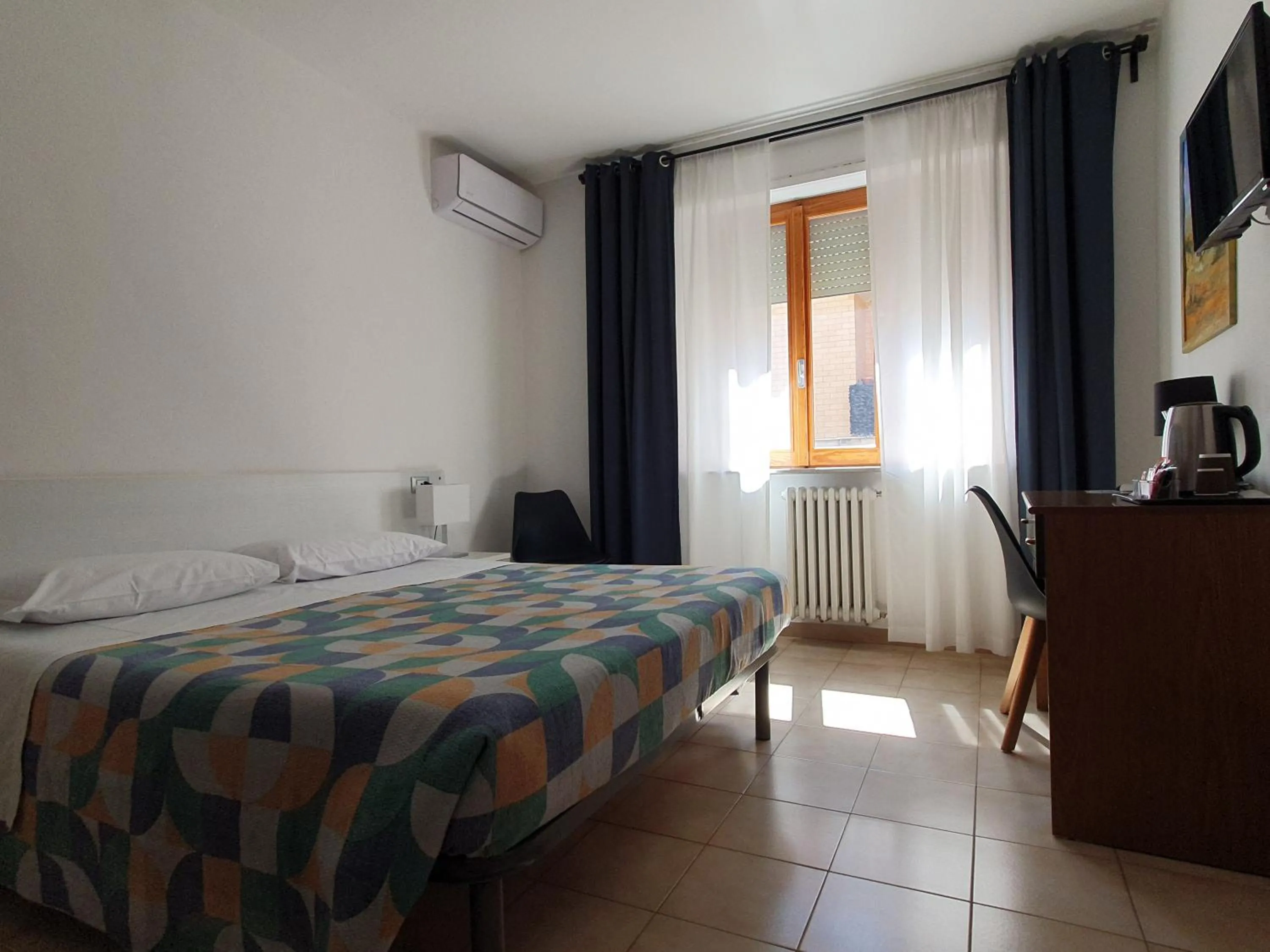 Bed in Hotel Cormorano