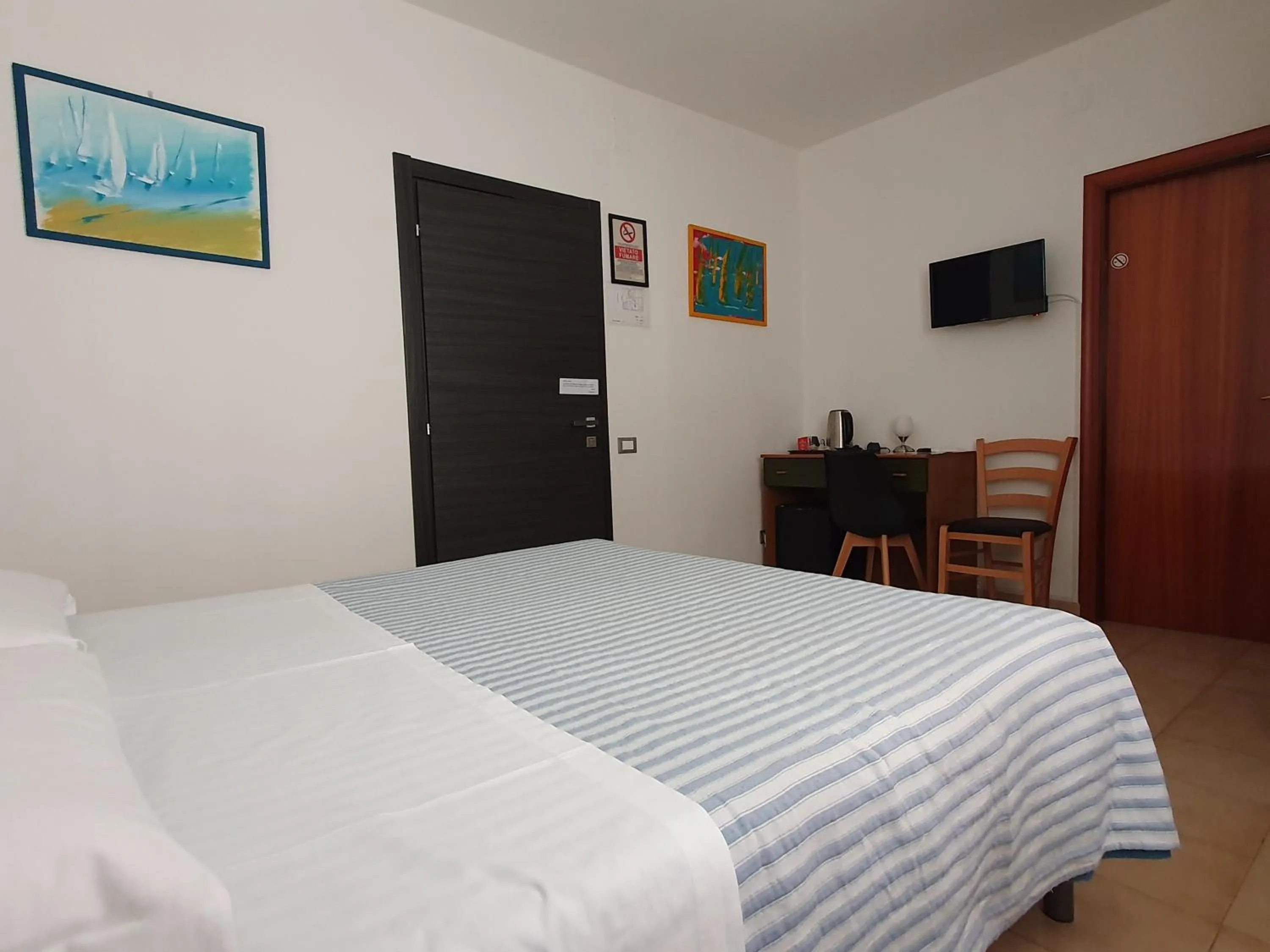 Bed in Hotel Cormorano