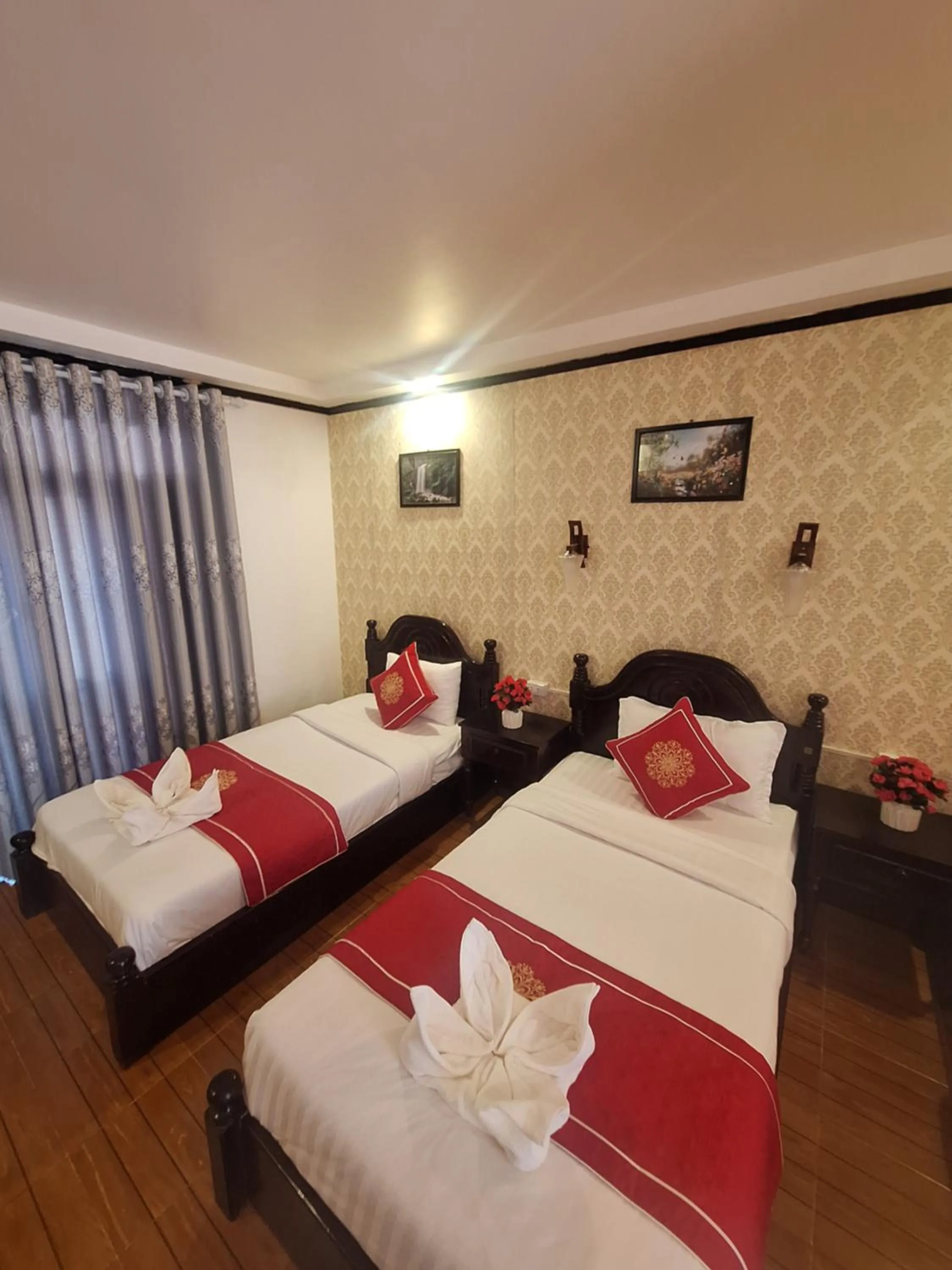 Bed in Luang Prabang Pavilion Hotel & Travel