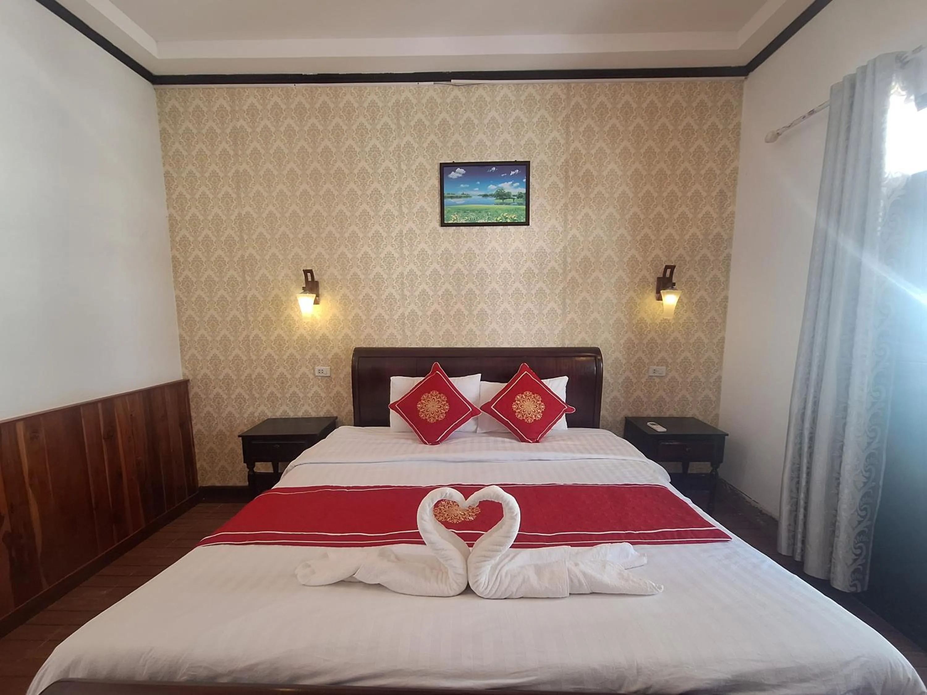 Bed in Luang Prabang Pavilion Hotel & Travel
