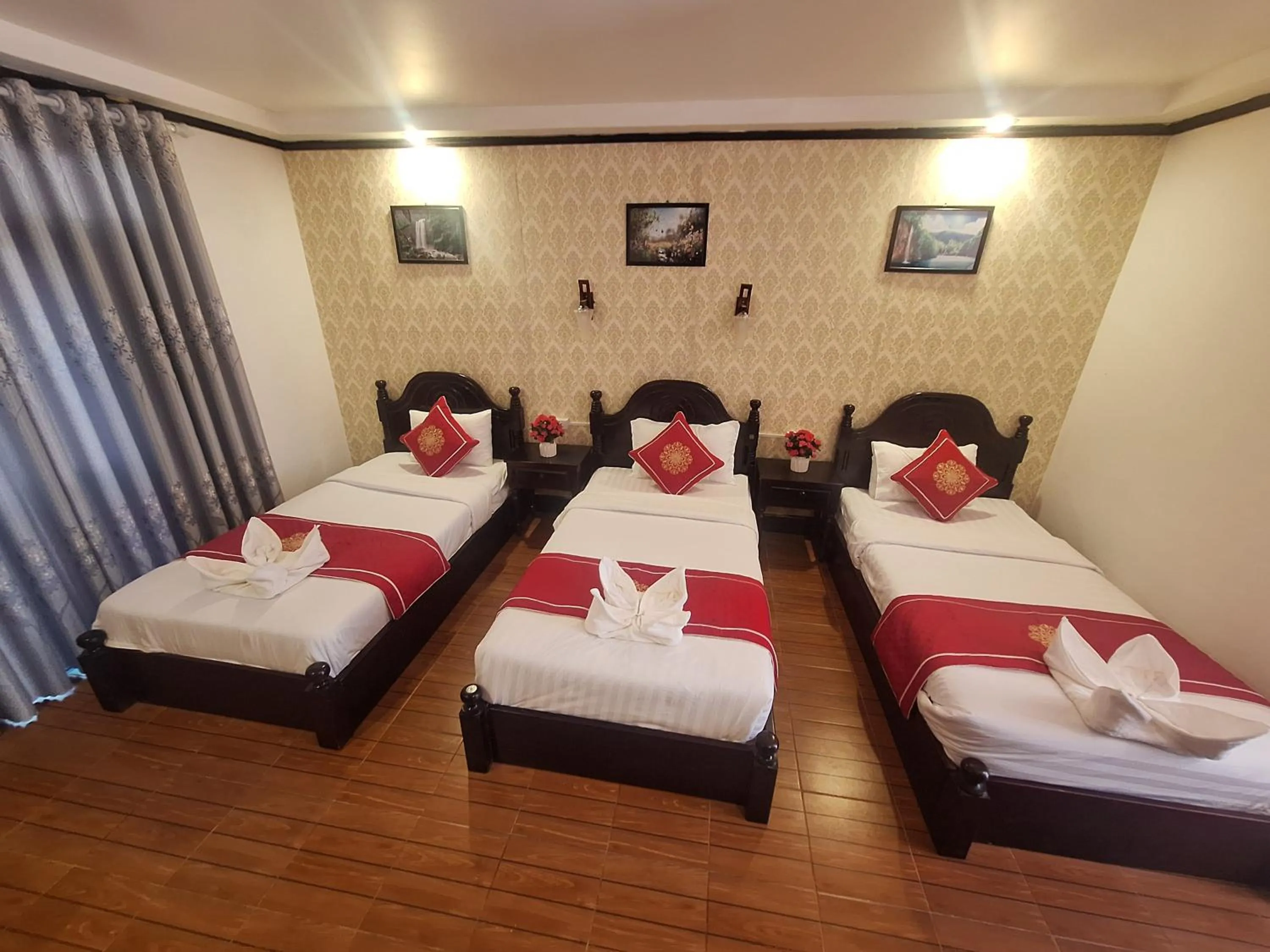 Bed in Luang Prabang Pavilion Hotel & Travel