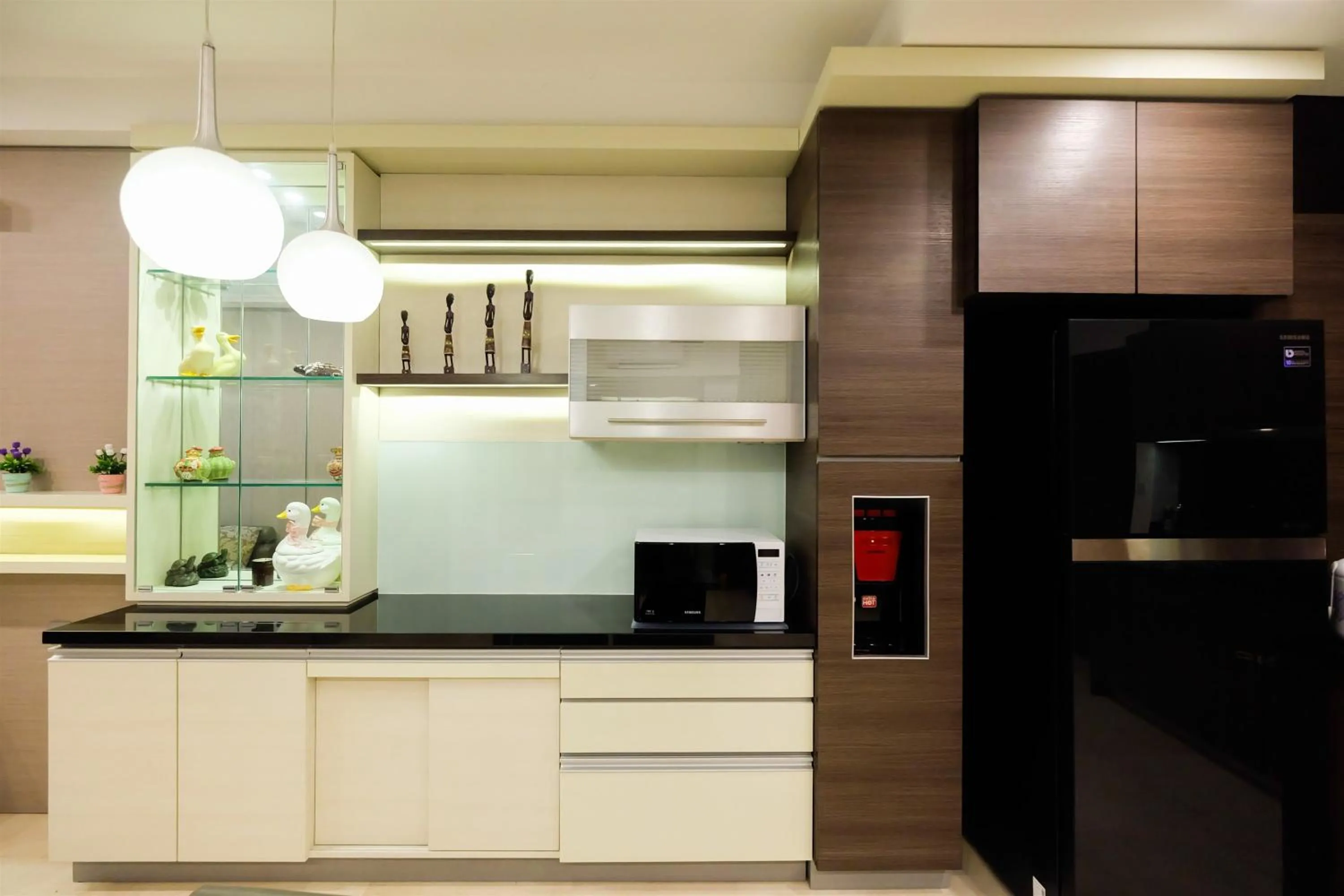 microwave in Modern Elegant Design 2BR L'Avenue Apartment By Travelio