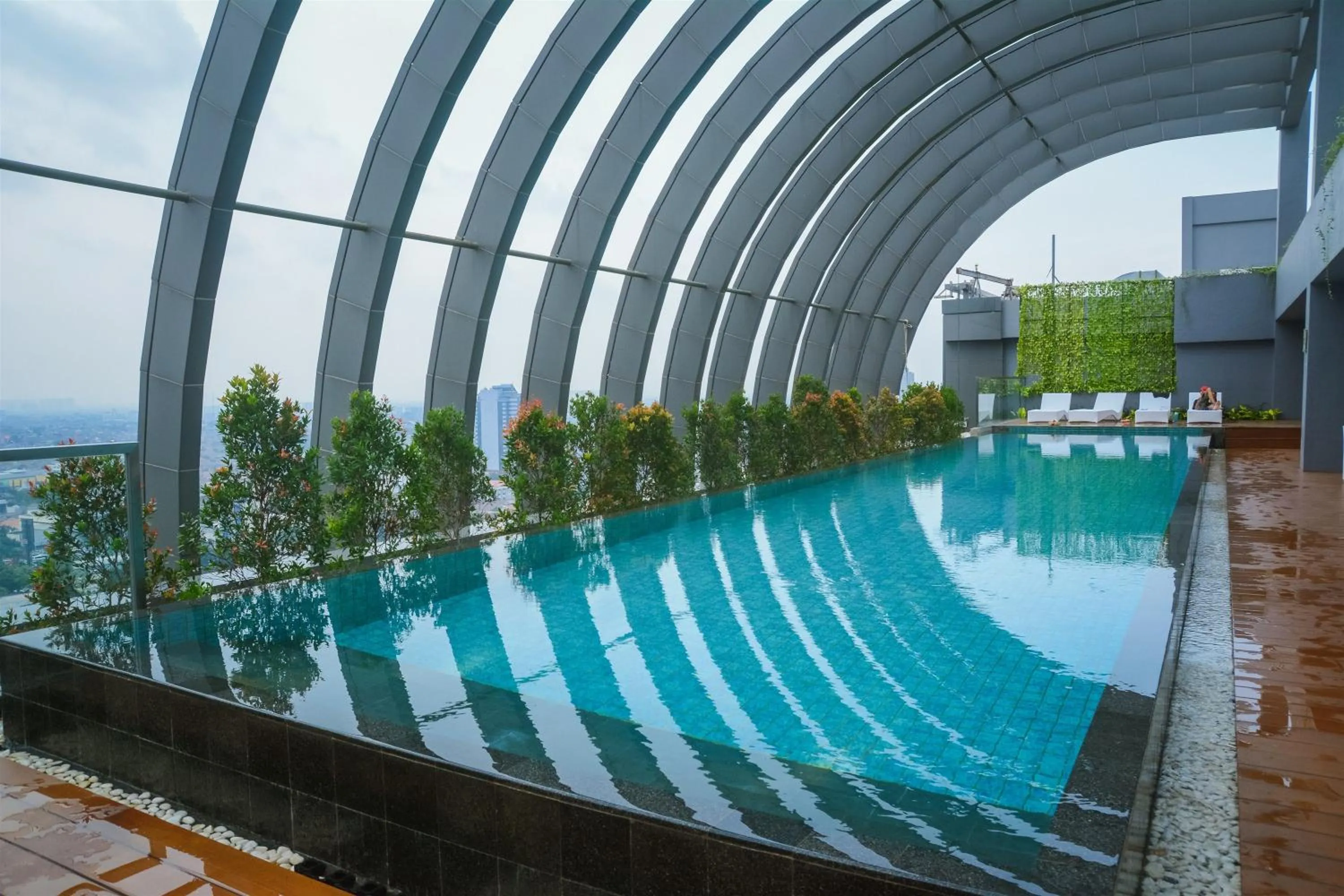 Swimming pool in Modern Elegant Design 2BR L'Avenue Apartment By Travelio