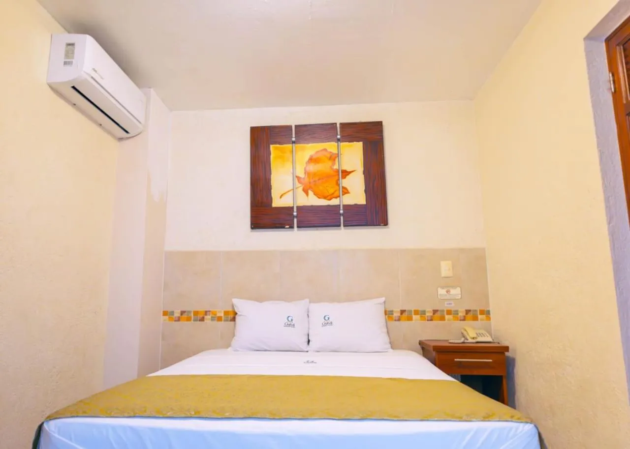 Bed in Hotel Guivá Huatulco