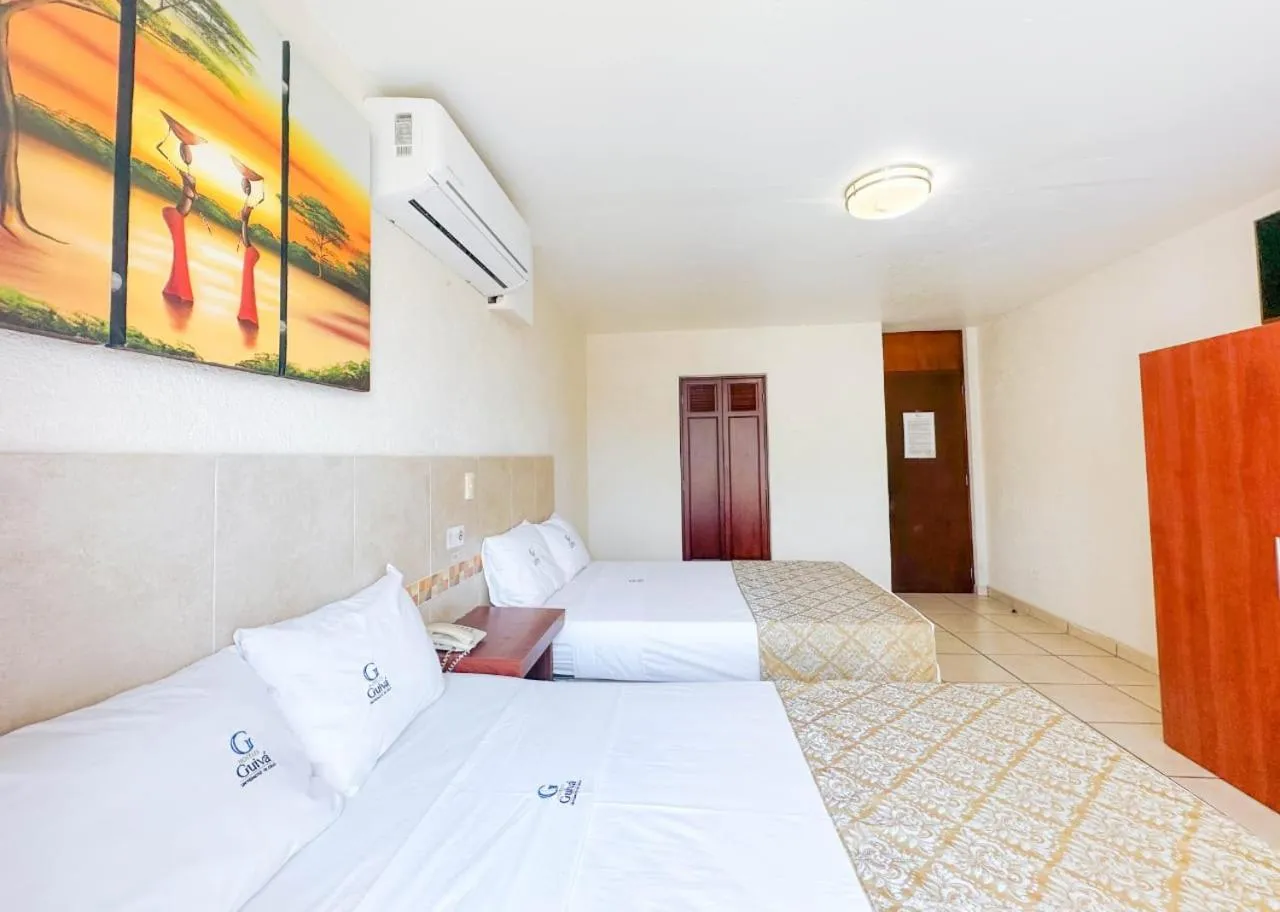 Bed in Hotel Guivá Huatulco