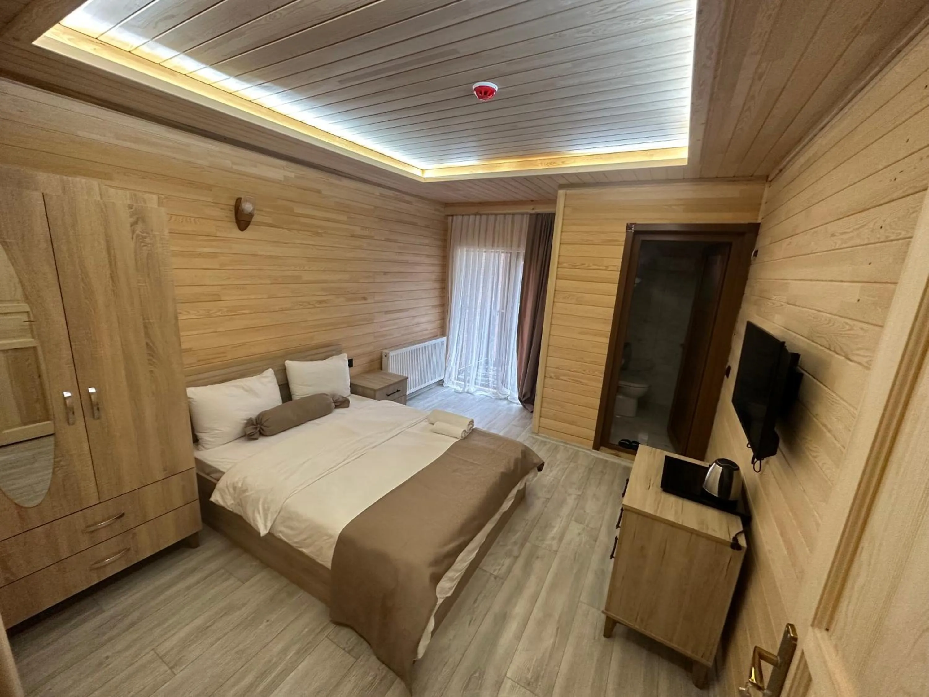 Communal lounge/ TV room in Haros Suite Hotel