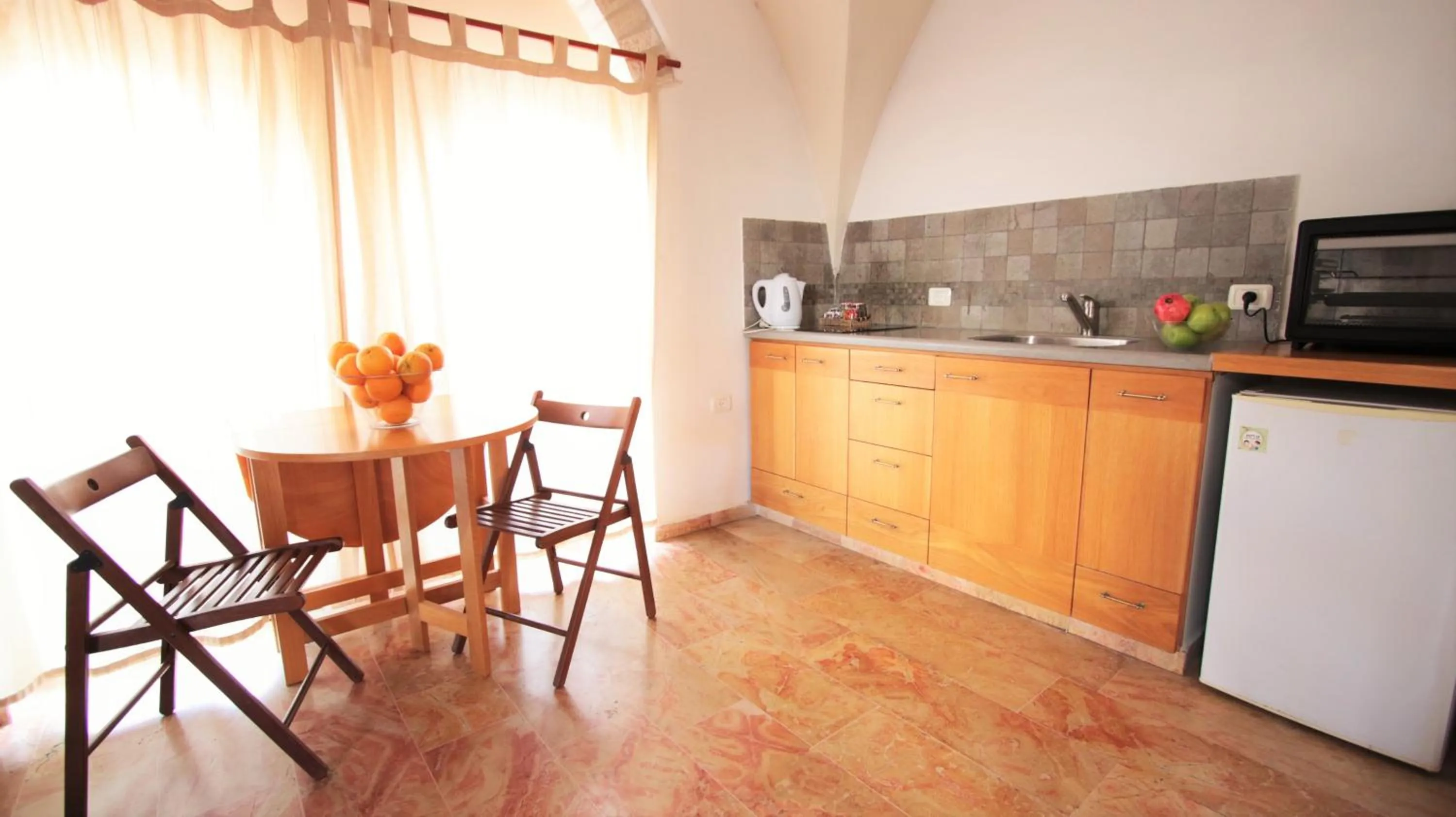 Kitchen or kitchenette in The Market Courtyard - Suites Hotel