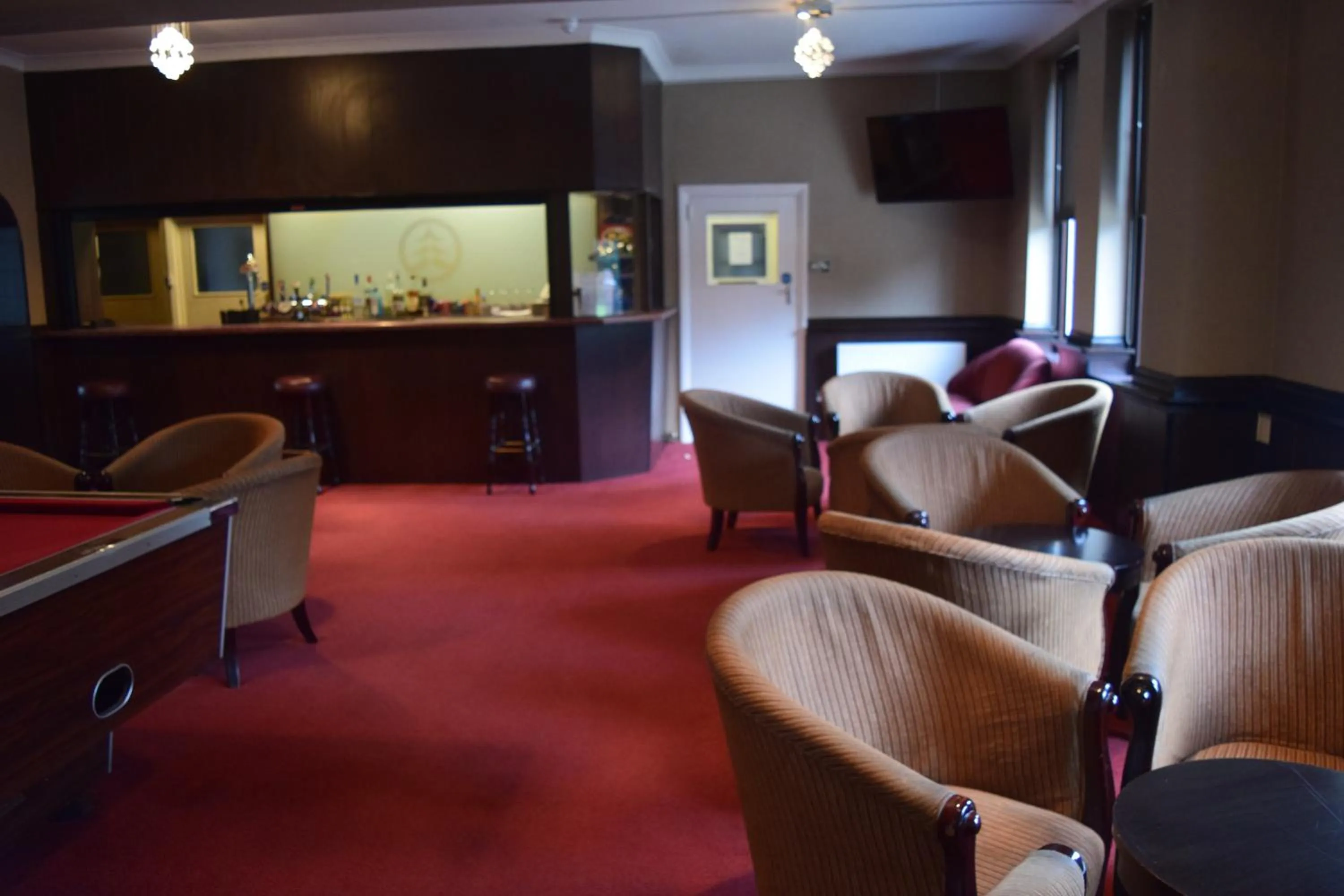 Communal lounge/ TV room, Seating Area in Rossmore Hotel