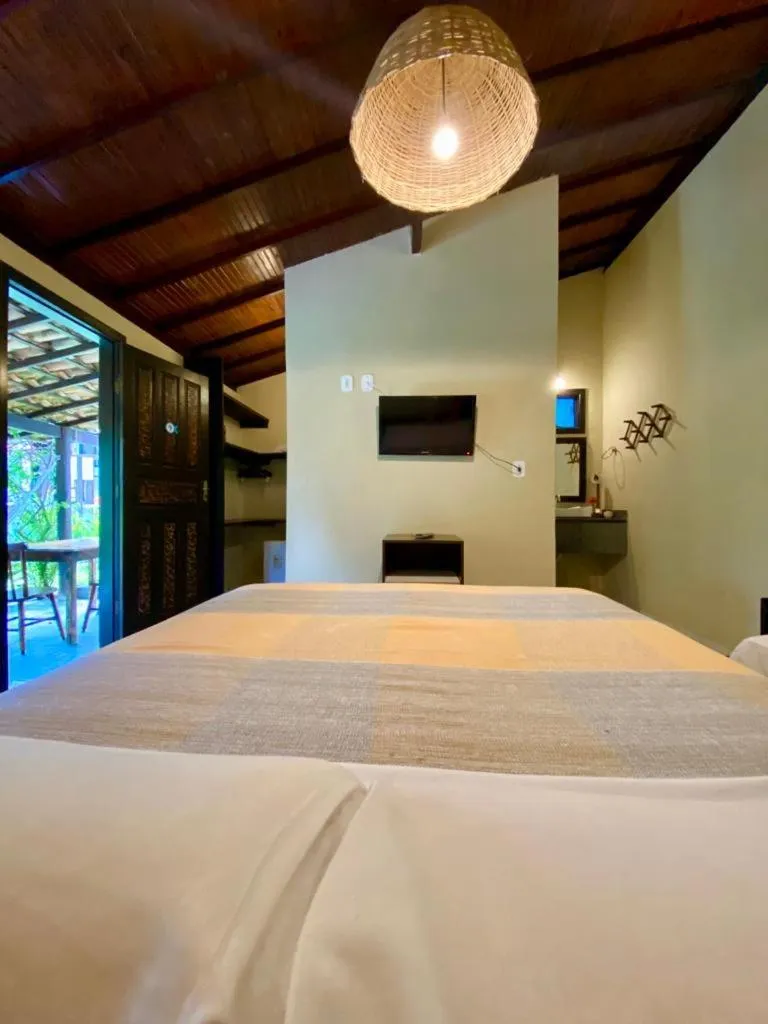 Bed in Pousada Tubarão