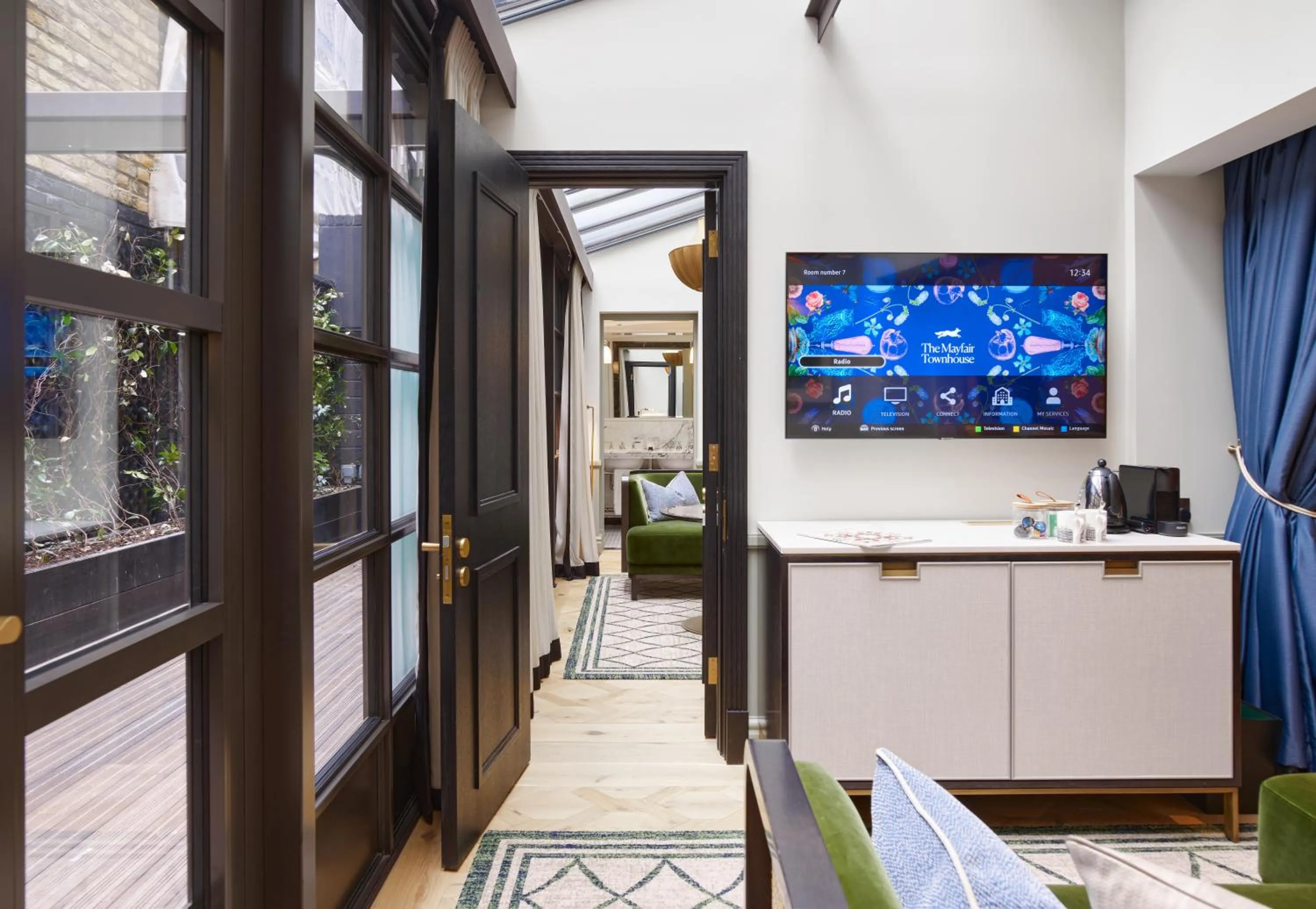 Communal lounge/ TV room in The Mayfair Townhouse - an Iconic Luxury Hotel