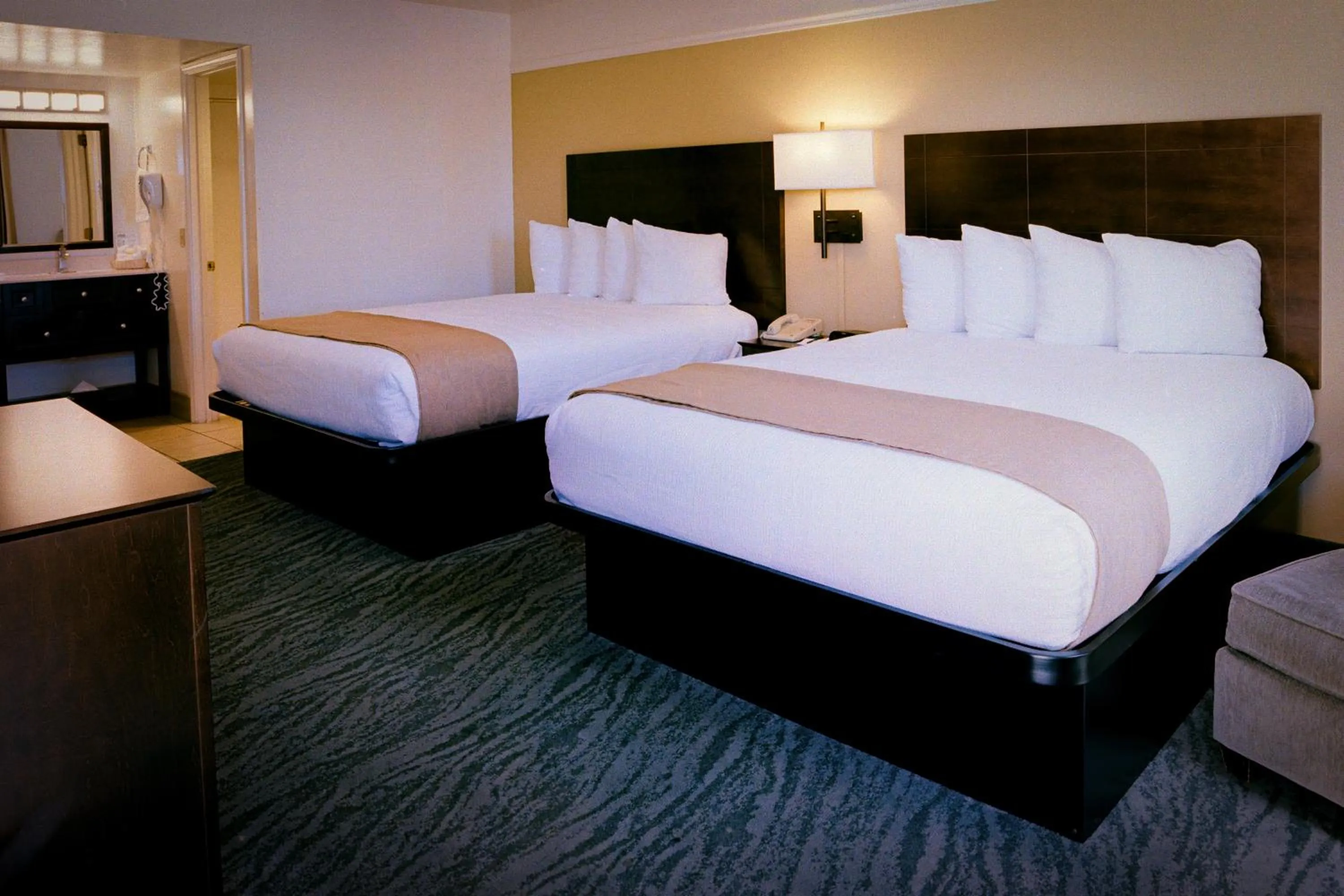 Bed in Pines Inn & Suites