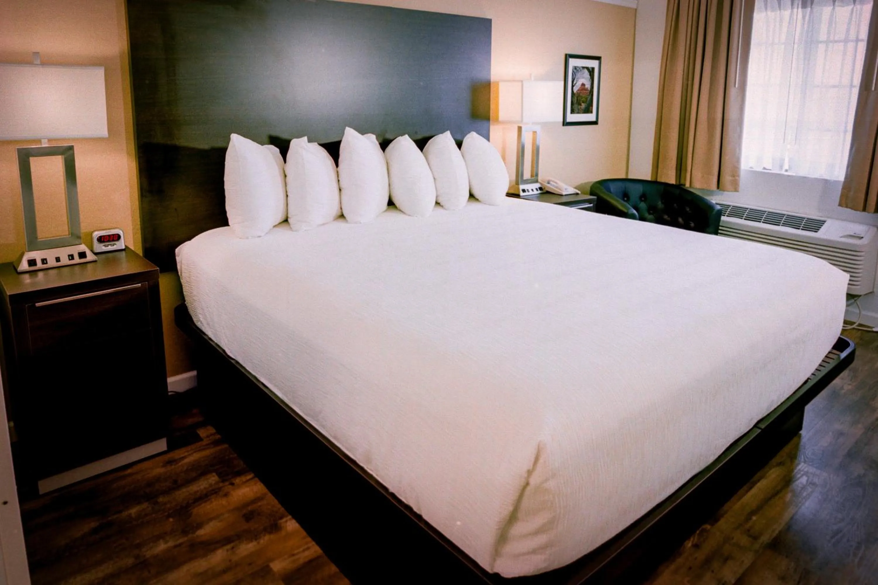 Bed in Pines Inn & Suites