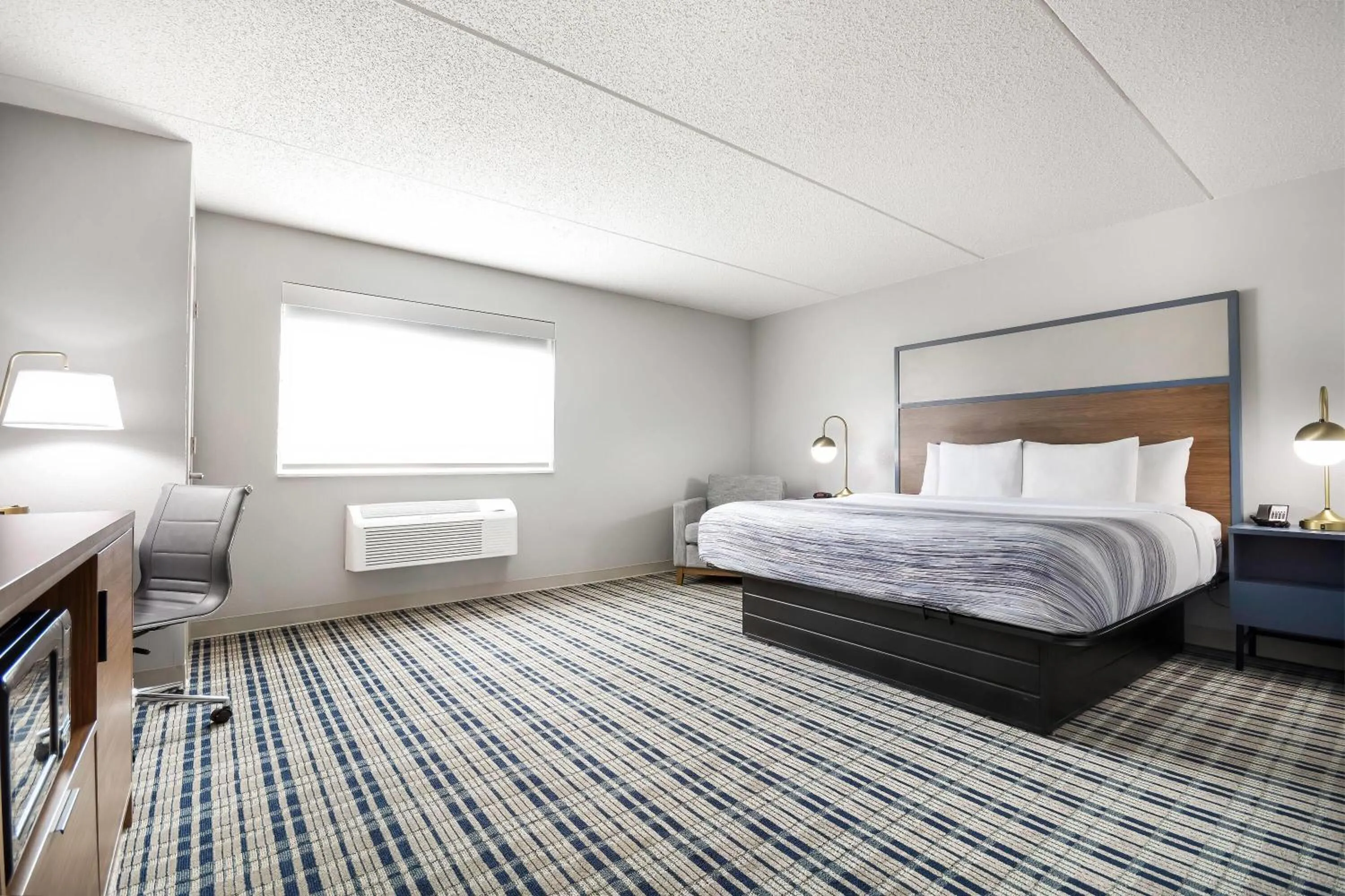 Bed in AmericInn by Wyndham Wausau