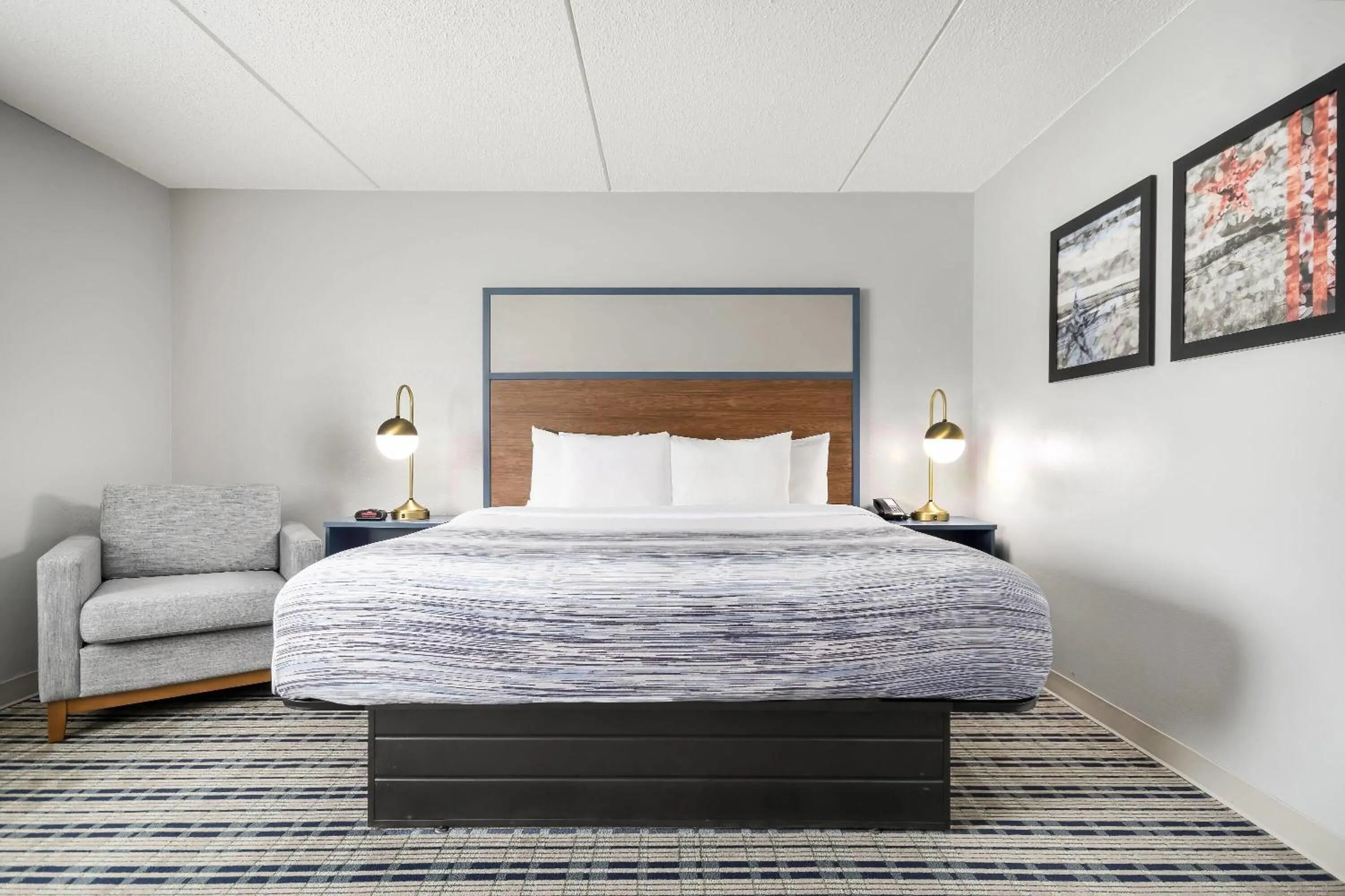 Bed in AmericInn by Wyndham Wausau