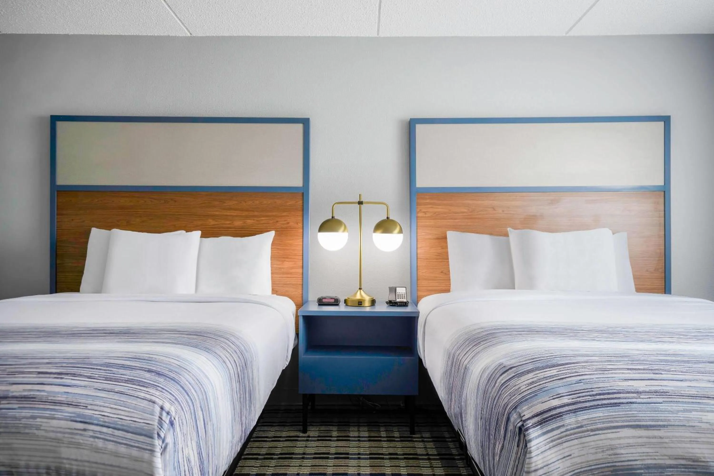 Bed in AmericInn by Wyndham Wausau