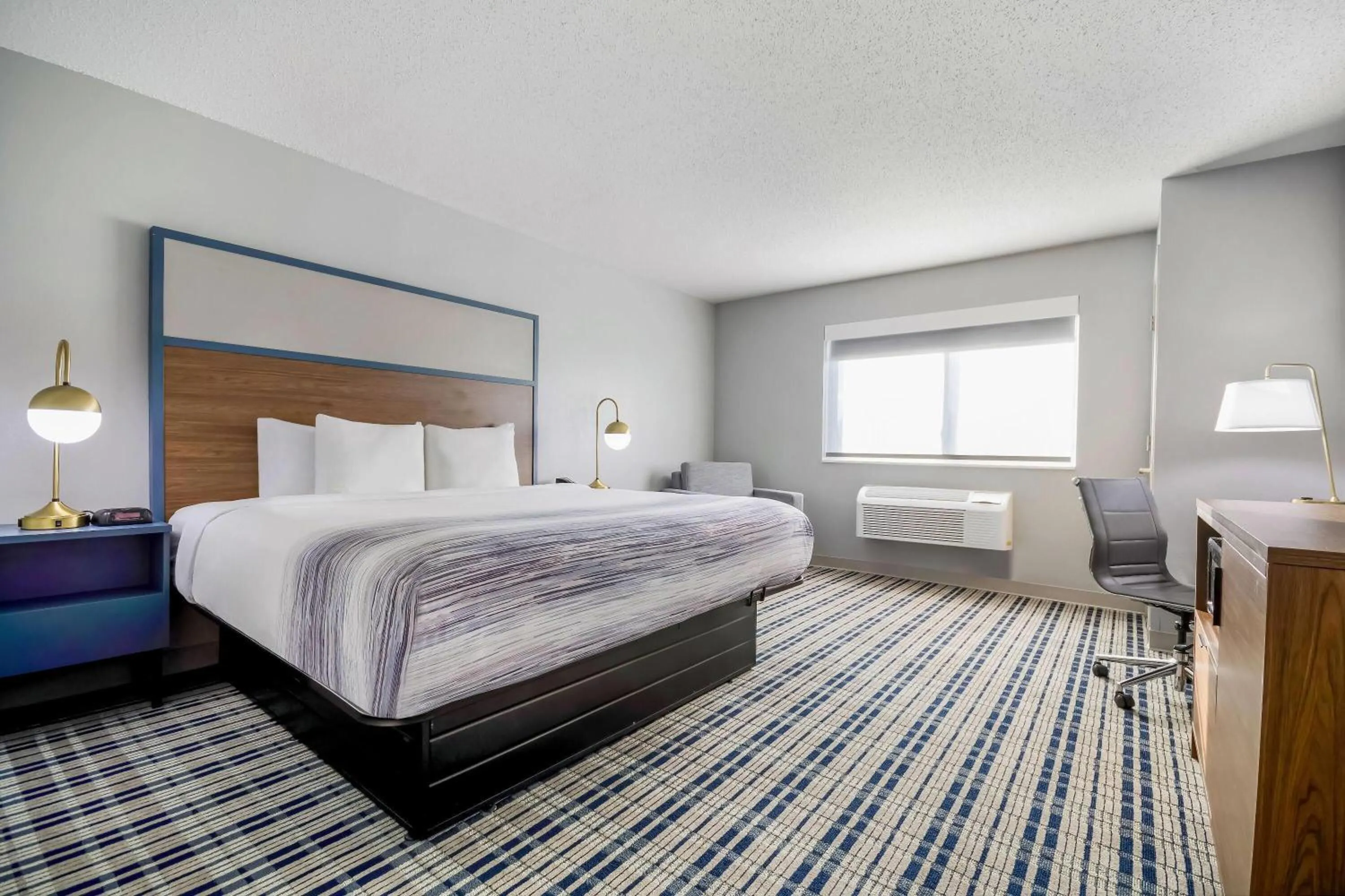 Bed in AmericInn by Wyndham Wausau