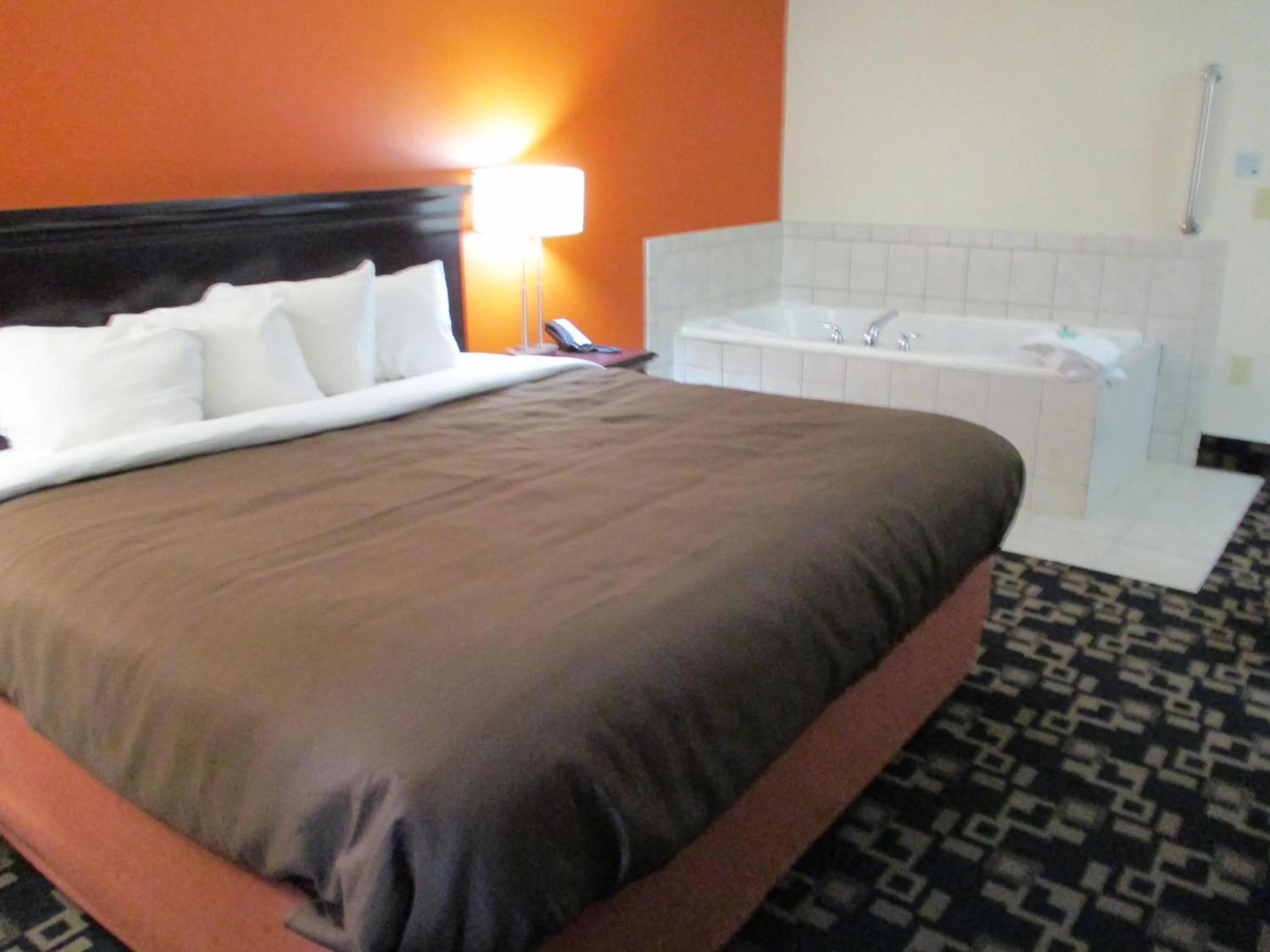 Bed in AmericInn by Wyndham Wausau