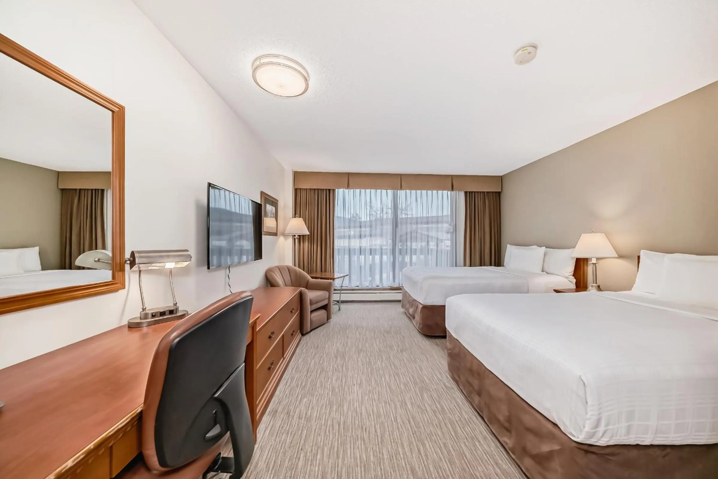 Bed in Jasper Inn & Suites by INNhotels