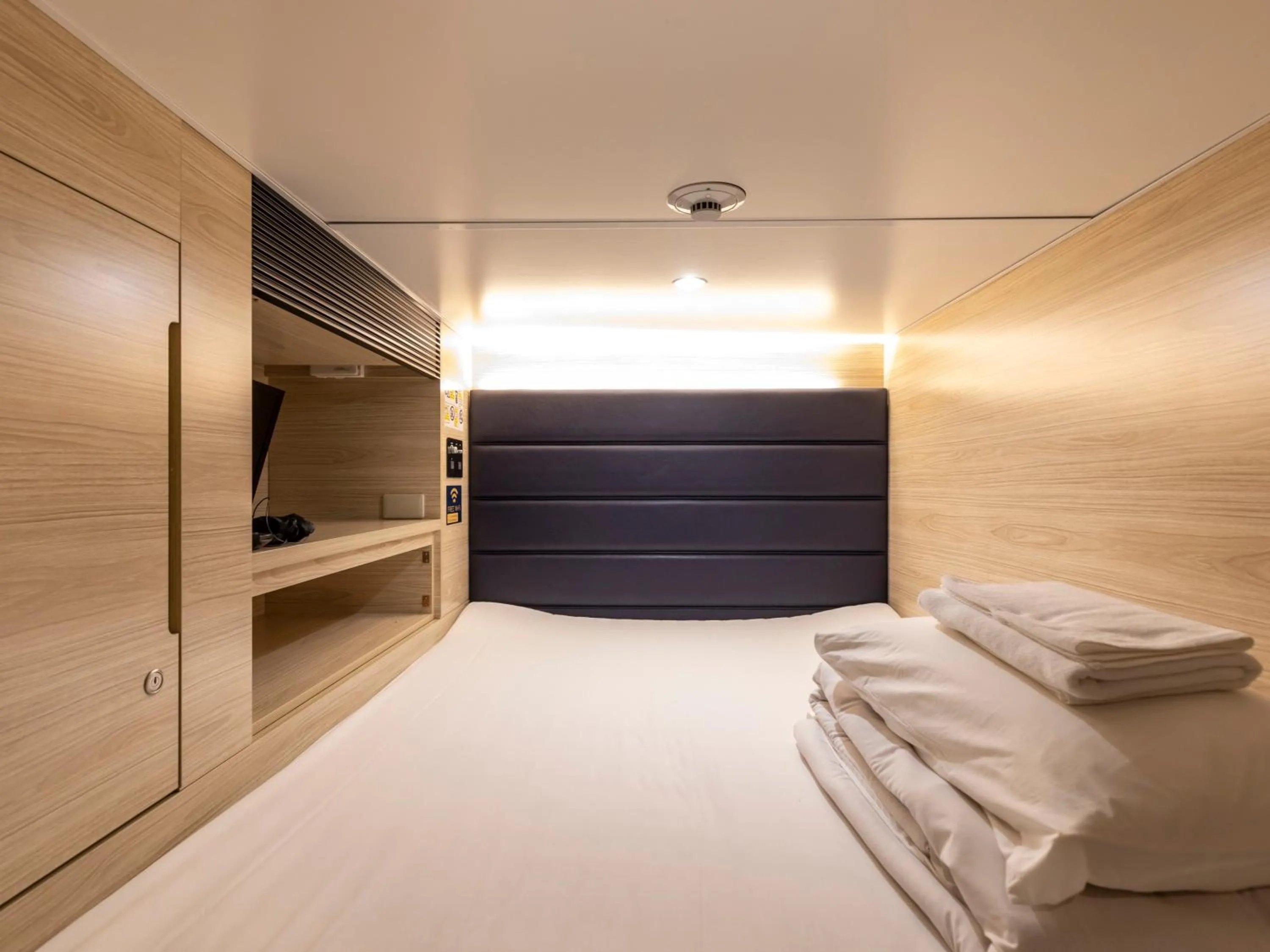 Bed in Tabist CapsuleHotel APODS Himeji Station