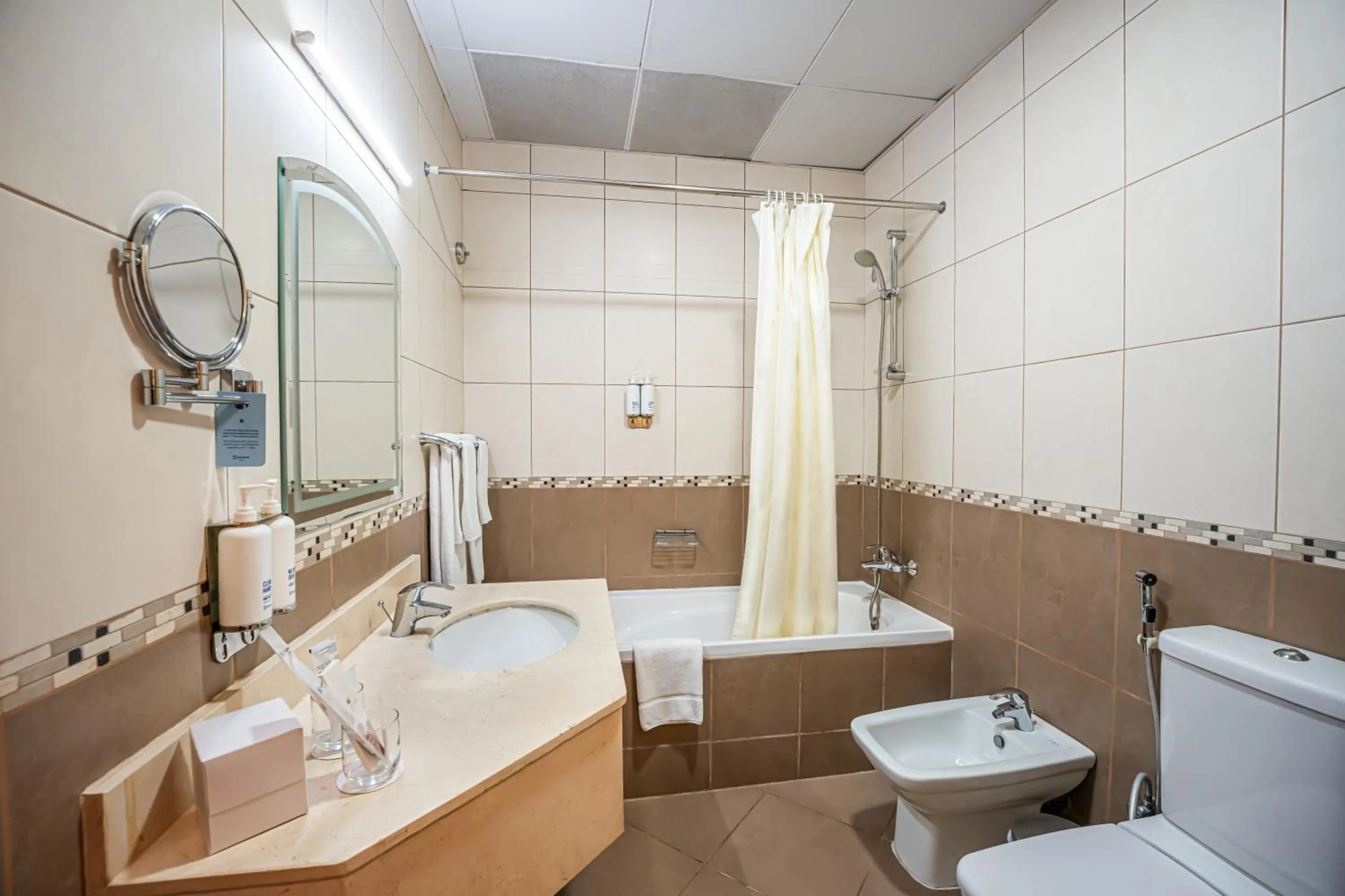 Toilet in Kingsgate Hotel Doha by Millennium Hotels
