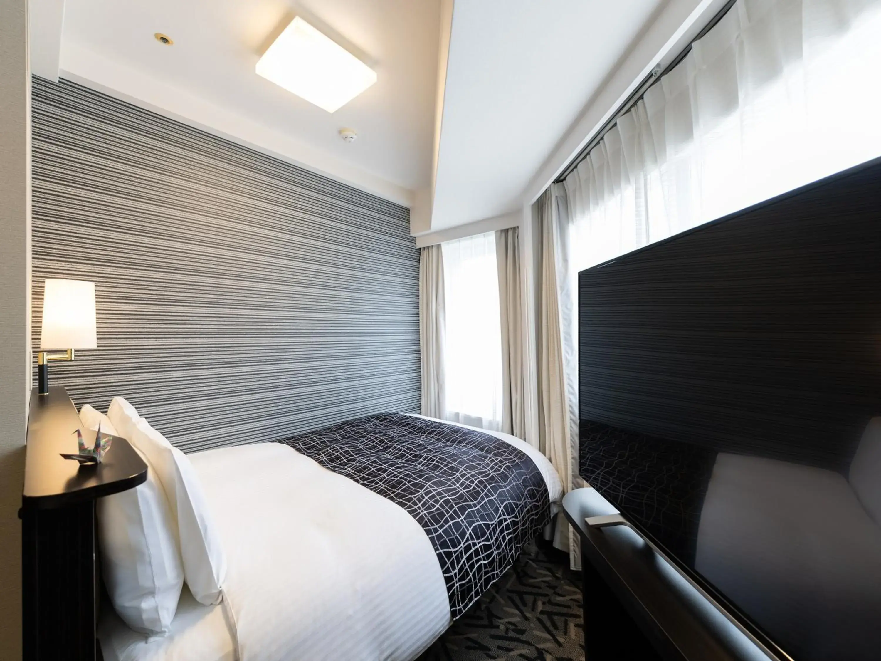 Bed in APA Hotel Kobe Sannomiya Bed in APA Hotel Kobe Sannomiya