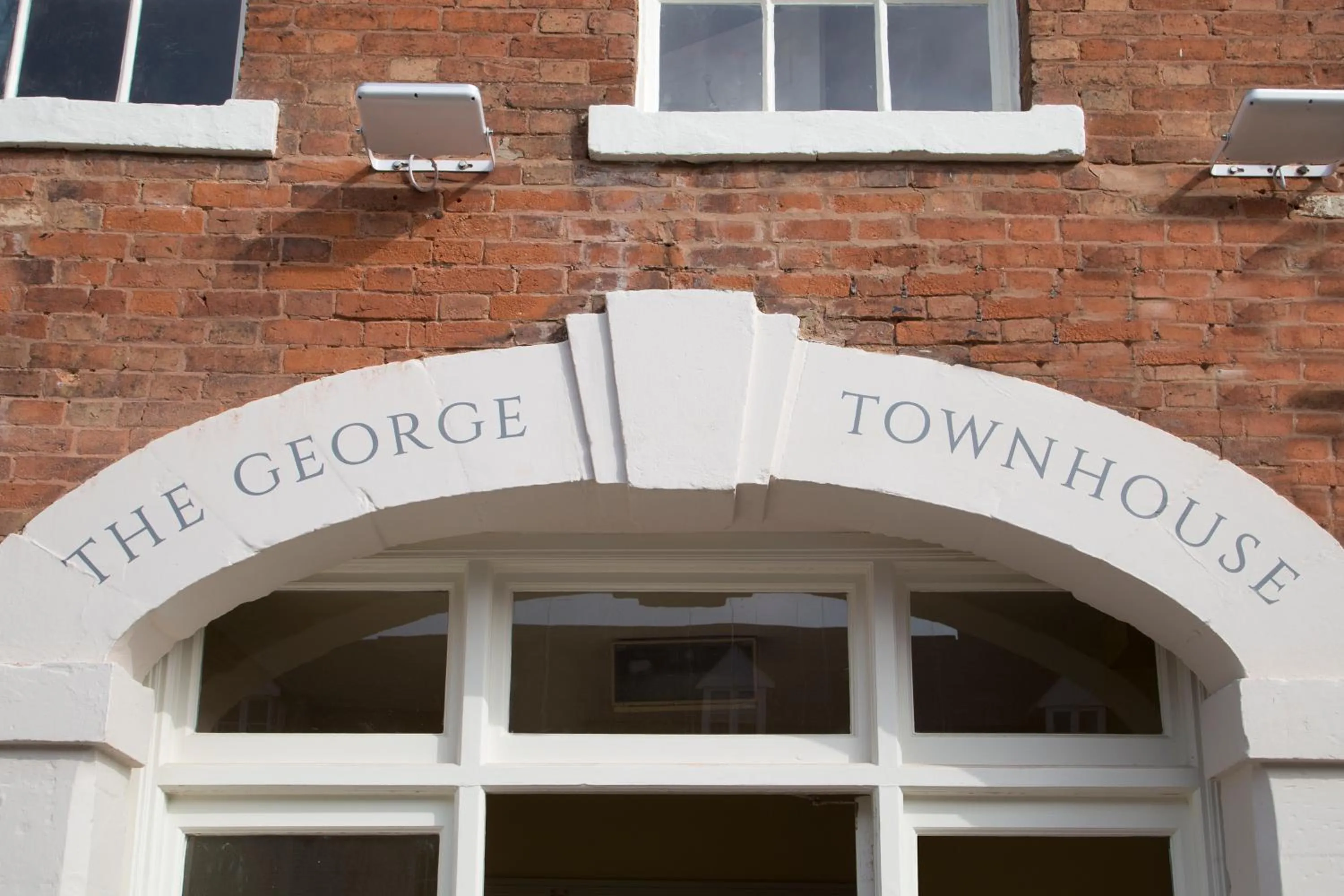Property logo or sign in The George Townhouse